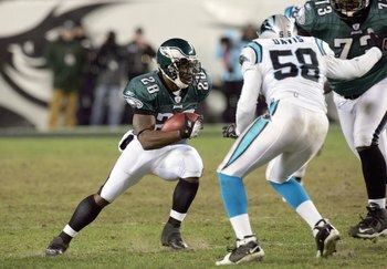 PHILADELPHIA - DECEMBER 4:  Correll Buckhalter #28 of the Philadelphia Eagles carries the ball against Thomas Davis #58 of the Carolina Panthers at Lincoln Financial Field on December 4, 2006 in Philadelphia, Pennsylvania. (Photo by Jim McIsaac/Getty Imag