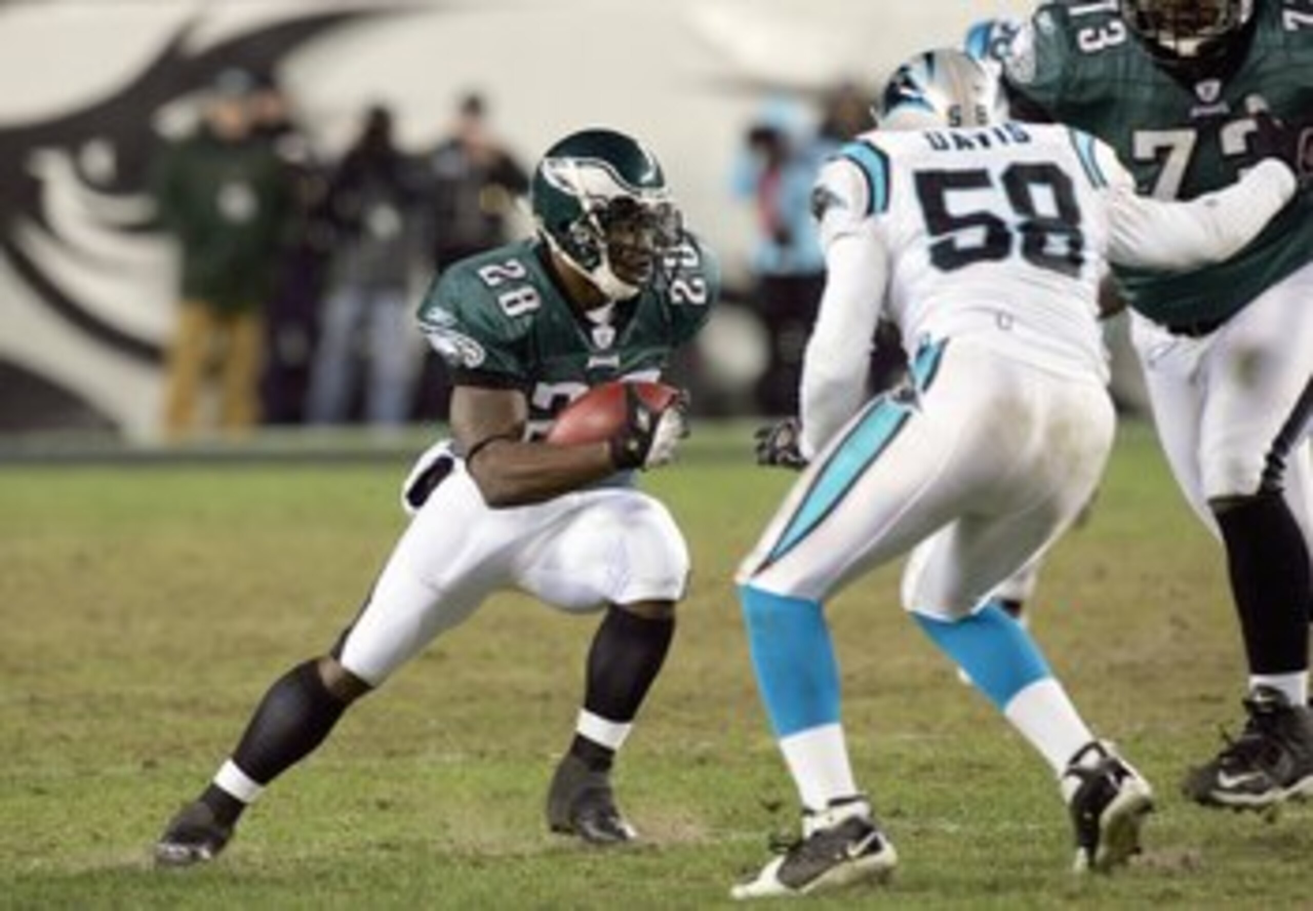 PHILADELPHIA - DECEMBER 4:  Correll Buckhalter #28 of the Philadelphia Eagles carries the ball against Thomas Davis #58 of the Carolina Panthers at Lincoln Financial Field on December 4, 2006 in Philadelphia, Pennsylvania. (Photo by Jim McIsaac/Getty Imag