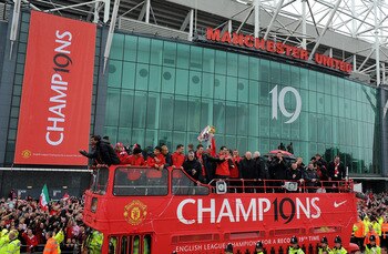 MANCHESTER, ENGLAND - MAY 30:  The Manchester United open top bus travels past Old Trafford during the Manchester United Premier League Winners Parade at Old Trafford on May 30, 2011 in Manchester, United Kingdom.  (Photo by Chris Brunskill/Getty Images)