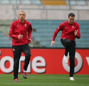 ROME - APRIL 03:  Dong Fangzhuo,Wes Brown and John O'Shea of Manchester United warm up during the Manchester United training session ahead of their UEFA Champions League Quarter Final match against AS Roma tomorrow night, at the Olympic Stadium on April 3