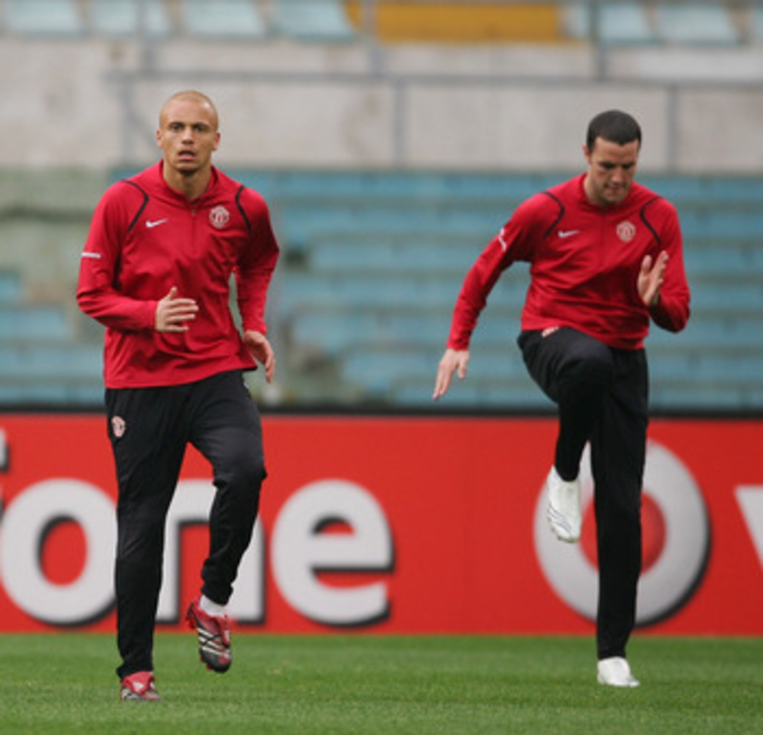 ROME - APRIL 03:  Dong Fangzhuo,Wes Brown and John O'Shea of Manchester United warm up during the Manchester United training session ahead of their UEFA Champions League Quarter Final match against AS Roma tomorrow night, at the Olympic Stadium on April 3
