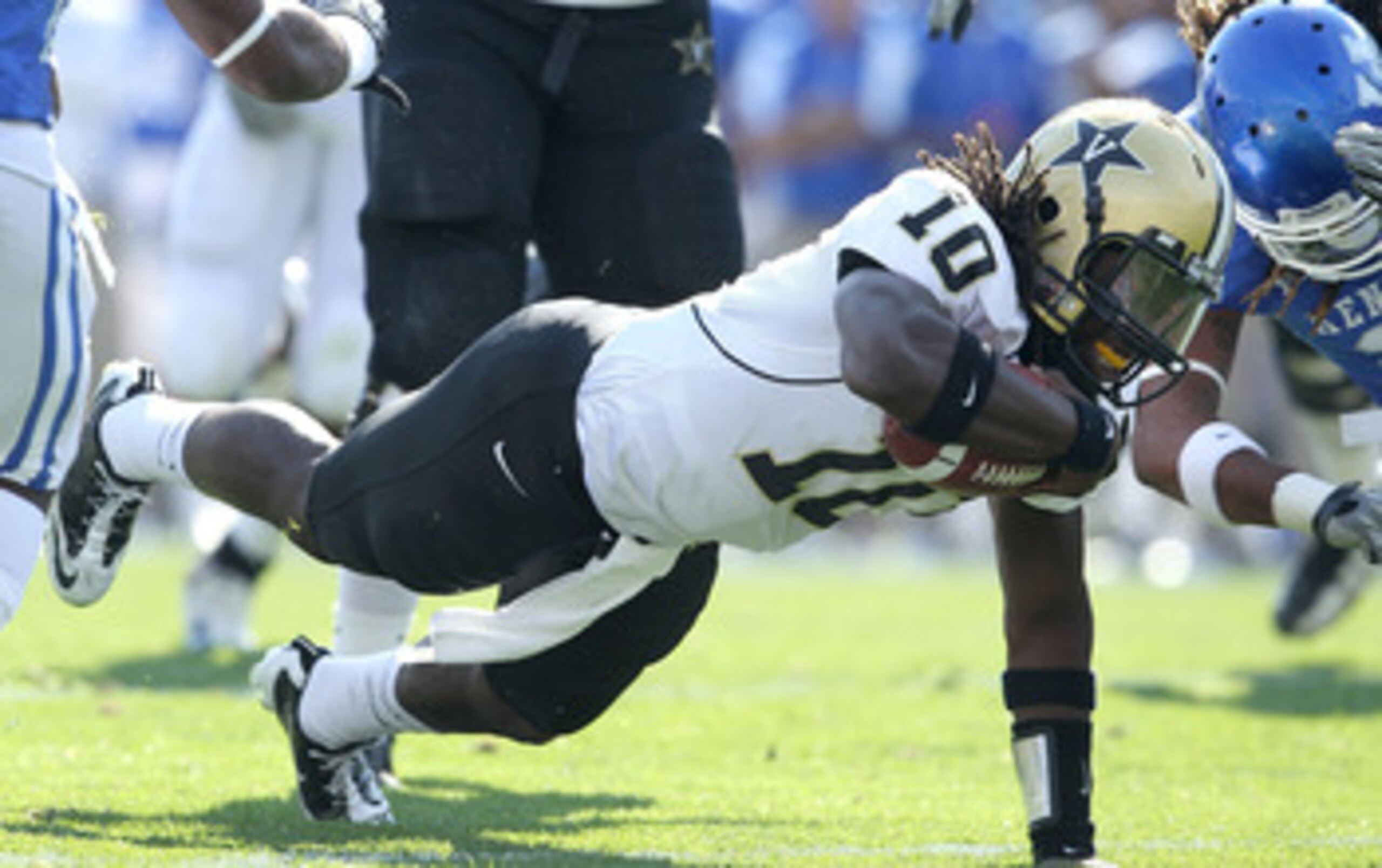PHILADELPHIA - DECEMBER 11: Running back Jared Hassin #7 of the Army Black Knights is tackled by defensive end Jabaree Tuani #98 of the Navy Midshipmen during a game on December 11, 2010 at Lincoln Financial Field in Philadelphia, Pennsylvania. The Midshi