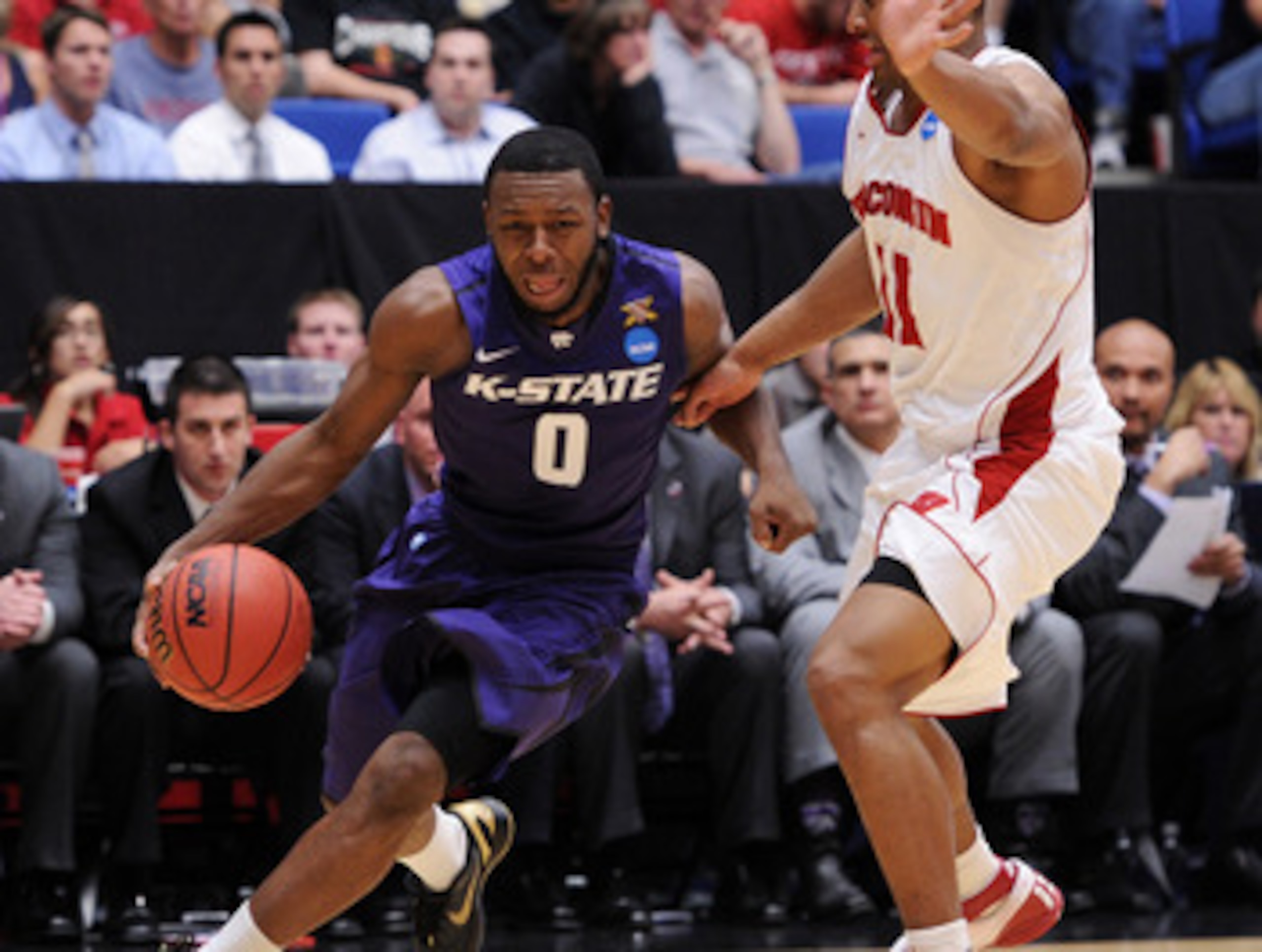 TUCSON, AZ - MARCH 19: Jacob Pullen #0 of the Kansas State Wildcats drives against Jordan Taylor #11 of the Wisconsin Badgers during the third round of the 2011 NCAA men's basketball tournament at McKale Center on March 19, 2011 in Tucson, Arizona. (Pho TUCSON, AZ - MARCH 19: Jacob Pullen #0 of the Kansas State Wildcats drives against Jordan Taylor #11 of the Wisconsin Badgers during the third round of the 2011 NCAA men's basketball tournament at McKale Center on March 19, 2011 in Tucson, Arizona. (Pho