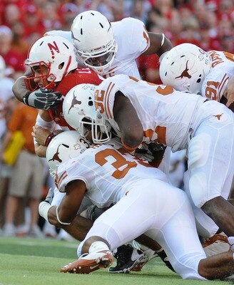 LINCOLN, NE - OCTOBER 16: Quarterback Zac Lee #5 of the Nebraska Cornhuskers is tackled by the Texas longhorn defense during second half action of their game at Memorial Stadium on October 16, 2010 in Lincoln, Nebraska. Texas Defeated Nebraska 20-13. (Pho