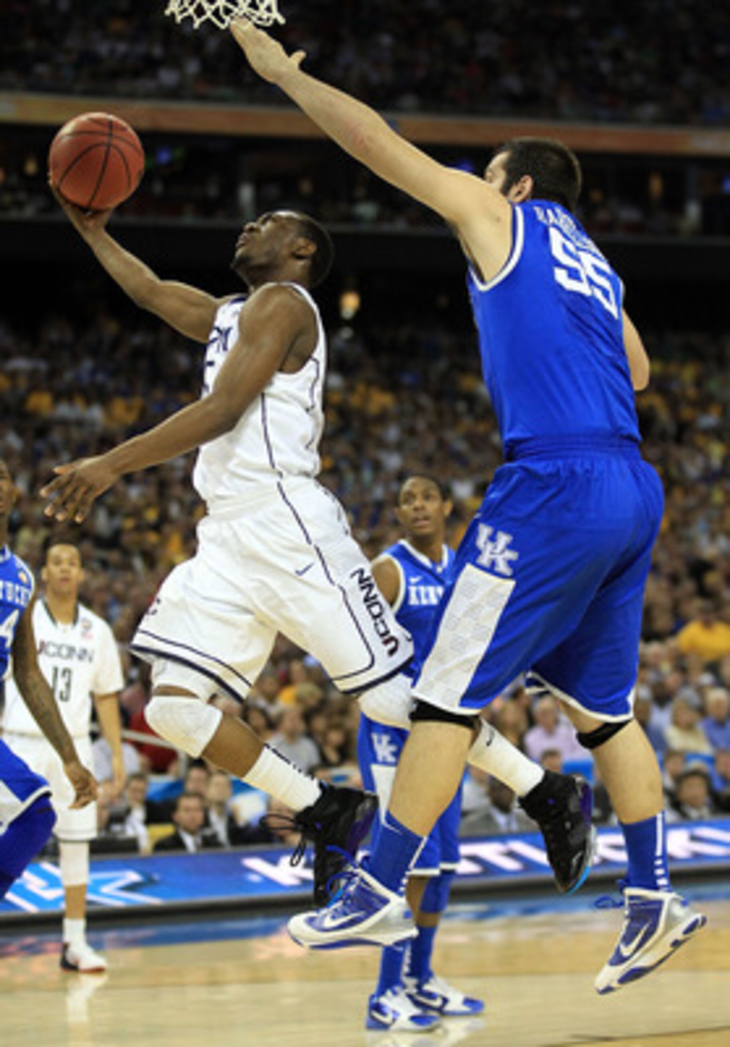 HOUSTON, TX - APRIL 02:  Kemba Walker #15 of the Connecticut Huskies goes to the hoop past Josh Harrellson #55 of the Kentucky Wildcats during the National Semifinal game of the 2011 NCAA Division I Men's Basketball Championship at Reliant Stadium on Apri