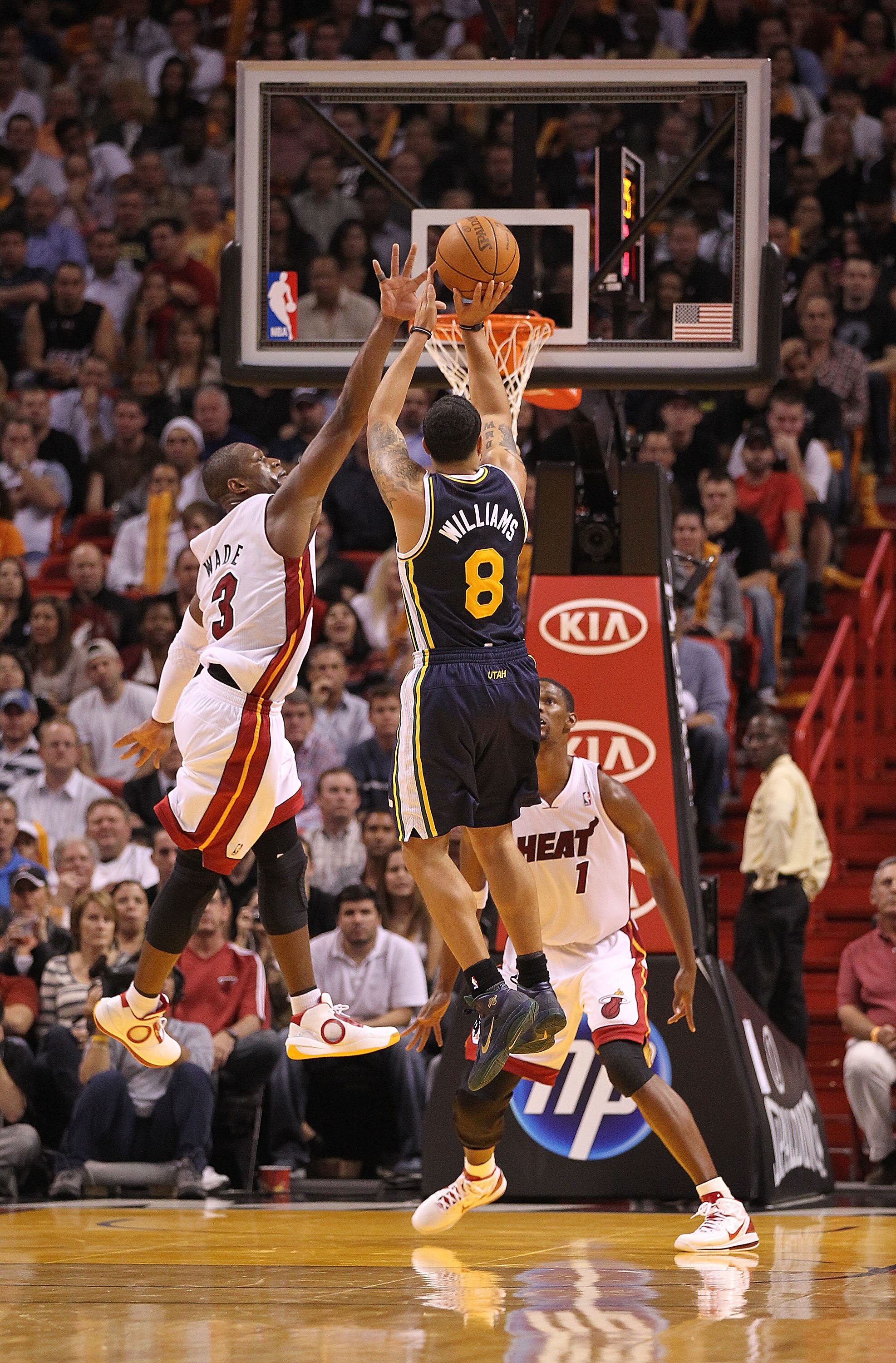 MIAMI - NOVEMBER 09:  Deron Williams #8 of the Utah Jazz shoots over Dwayne Wade #3 during a game agsinst the Miami Heat at American Airlines Arena on November 9, 2010 in Miami, Florida. NOTE TO USER: User expressly acknowledges and agrees that, by downlo