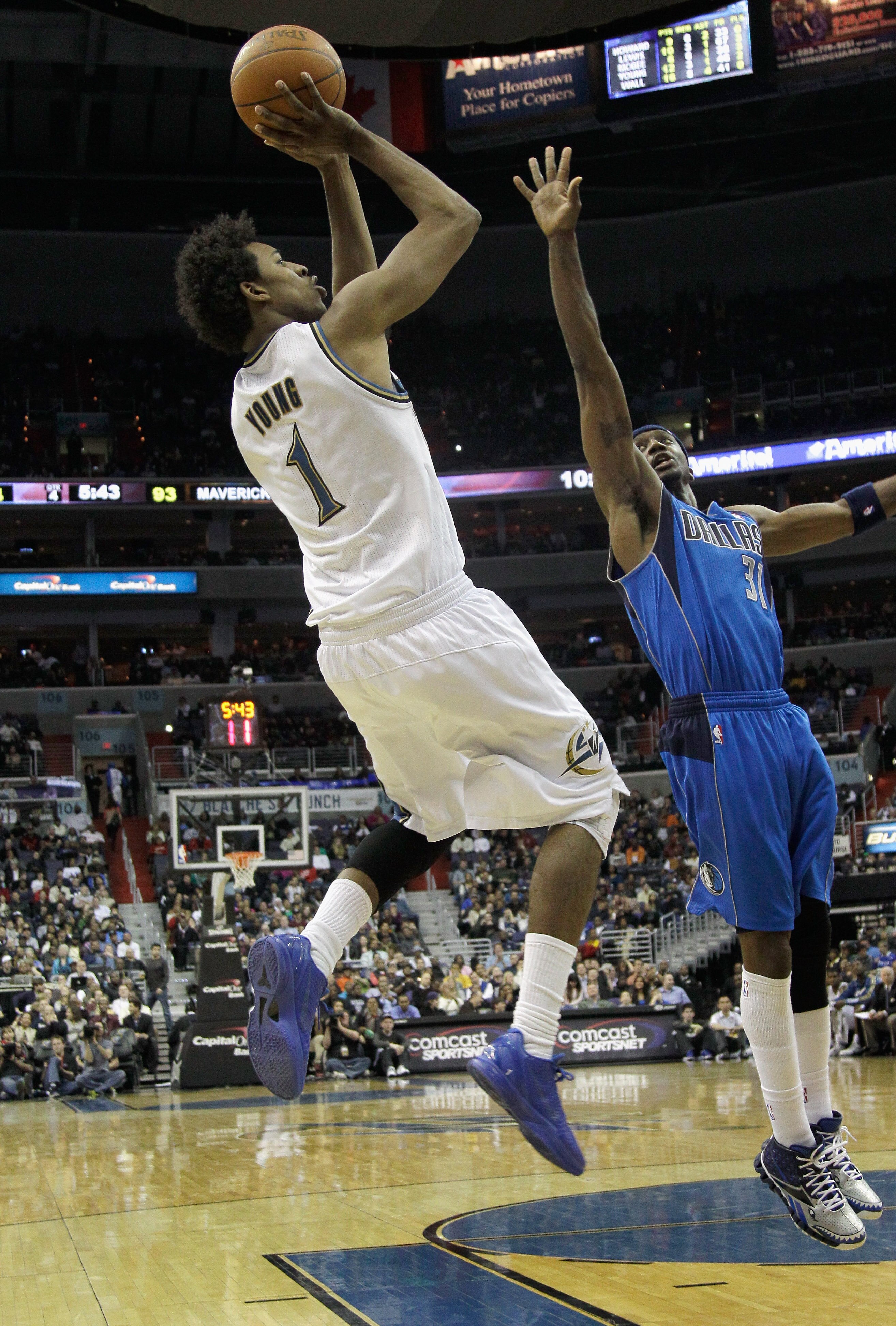 WASHINGTON, DC - FEBRUARY 26:  Nick Young #1 of the Washington Wizards shoots over Jason Terry #31 of the Dallas Mavericks at the Verizon Center on February 26, 2011 in Washington, DC. NOTE TO USER: User expressly acknowledges and agrees that, by download