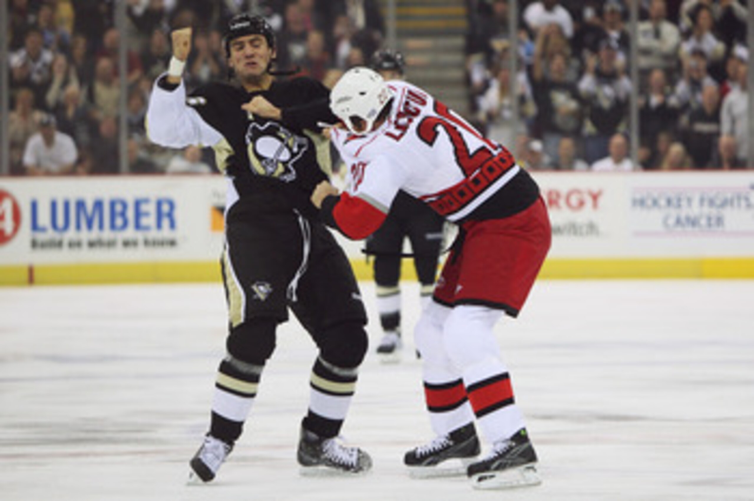 PITTSBURGH - OCTOBER 23:  Paul Bissonnette #16 of the Pittsburgh Penguins and Dan LaCouture #20 of the Carolina Hurricanes exchange punches during a first period fight on October 23, 2008 at Mellon Arena in Pittsburgh, Pennsylvania.  (Photo by Jamie Sabau