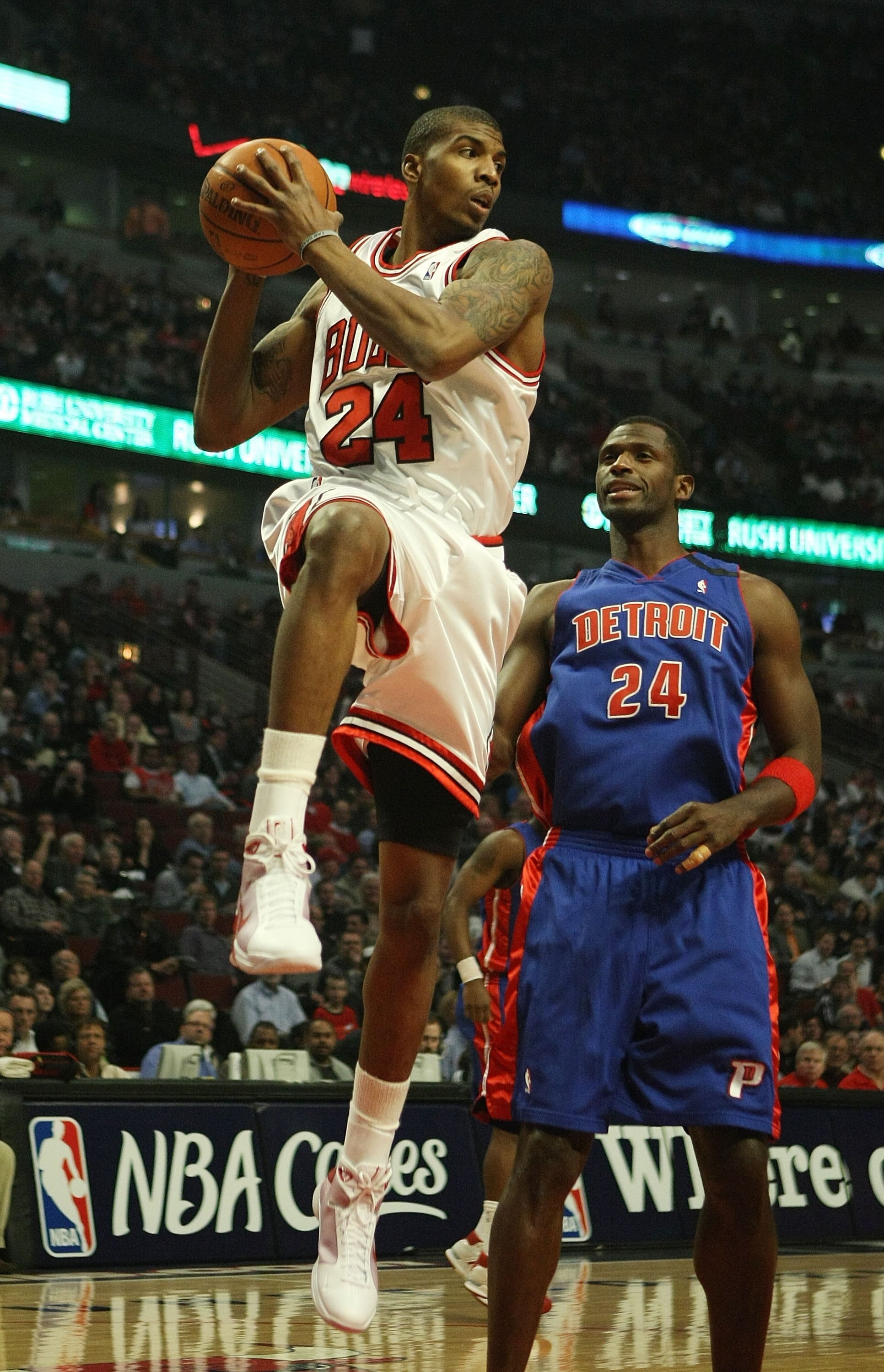 CHICAGO - MARCH 24: Tyrus Thomas #24 of the Chicago Bulls grabs a rebound in front of Antonio McDyees #24 of the Detroit Pistons on March 24, 2009 at the United Center in Chicago, Illinois. The Bulls defeated the Pistons 99-91. NOTE TO USER: User expressl