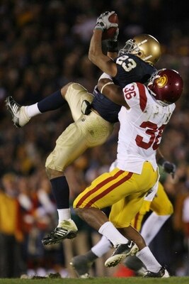 SOUTH BEND, IN - OCTOBER 17: Wide receiver Golden Tate #23 of the Notre Dame Fighting Irish makes a first down catch with one minute left in the game against Josh Pinkard #36 of the USC Trojans at Notre Dame Stadium on October 17, 2009 in South Bend, Indi
