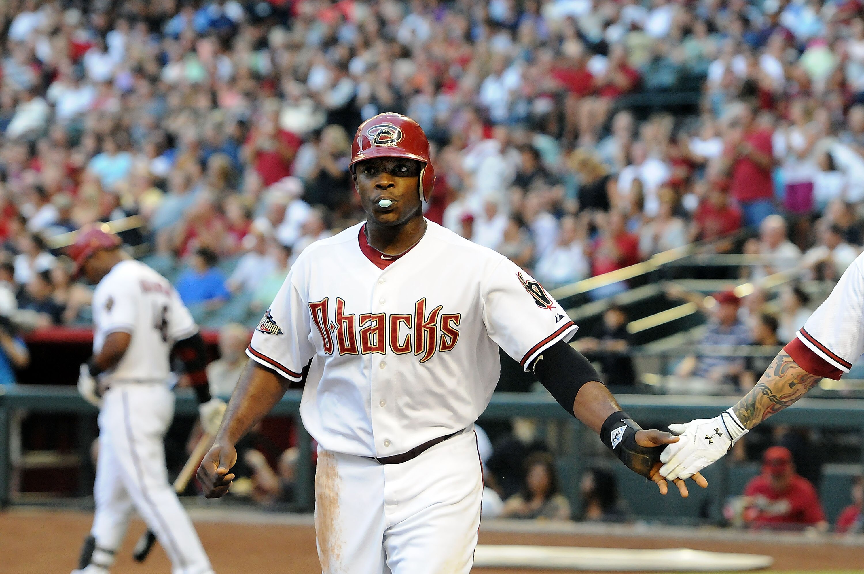 PHOENIX, AZ - JUNE 17:  Justin Upton #10 of the Arizona Diamondbacks celebrates with teammates after scoring a run in the first inning against the Chicago White Sox at Chase Field on June 17, 2011 in Phoenix, Arizona.  (Photo by Norm Hall/Getty Images)