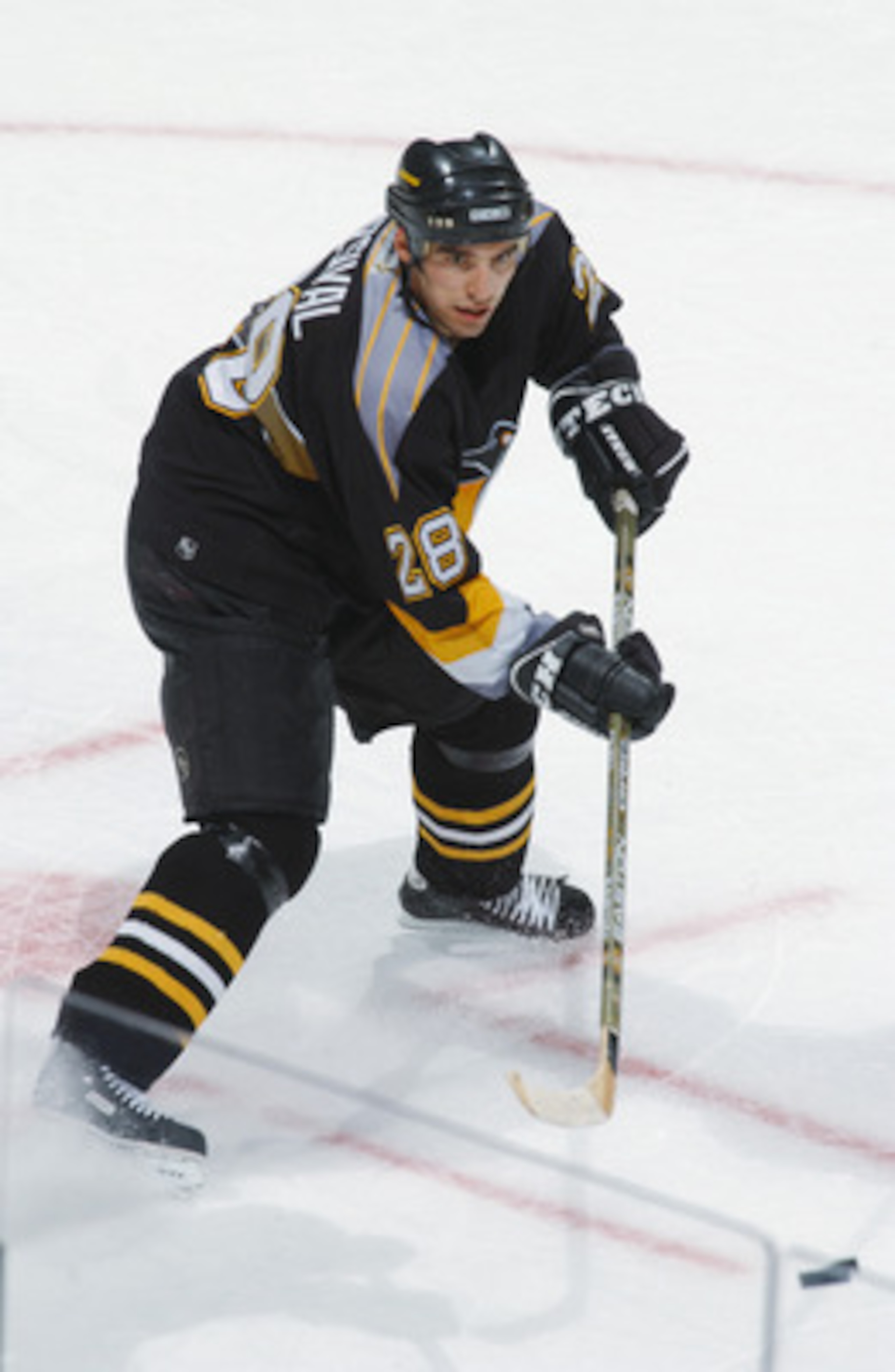 WASHINGTON - DECEMBER 22:  Defenseman Michal Rozsival #28 of the Pittsburgh Penguins passes the puck during the NHL game against the Washington Capitals at the MCI Center in Washington D.C. on December 22, 2001.  The Penguins tied the Capitals 4-4.  (Phot