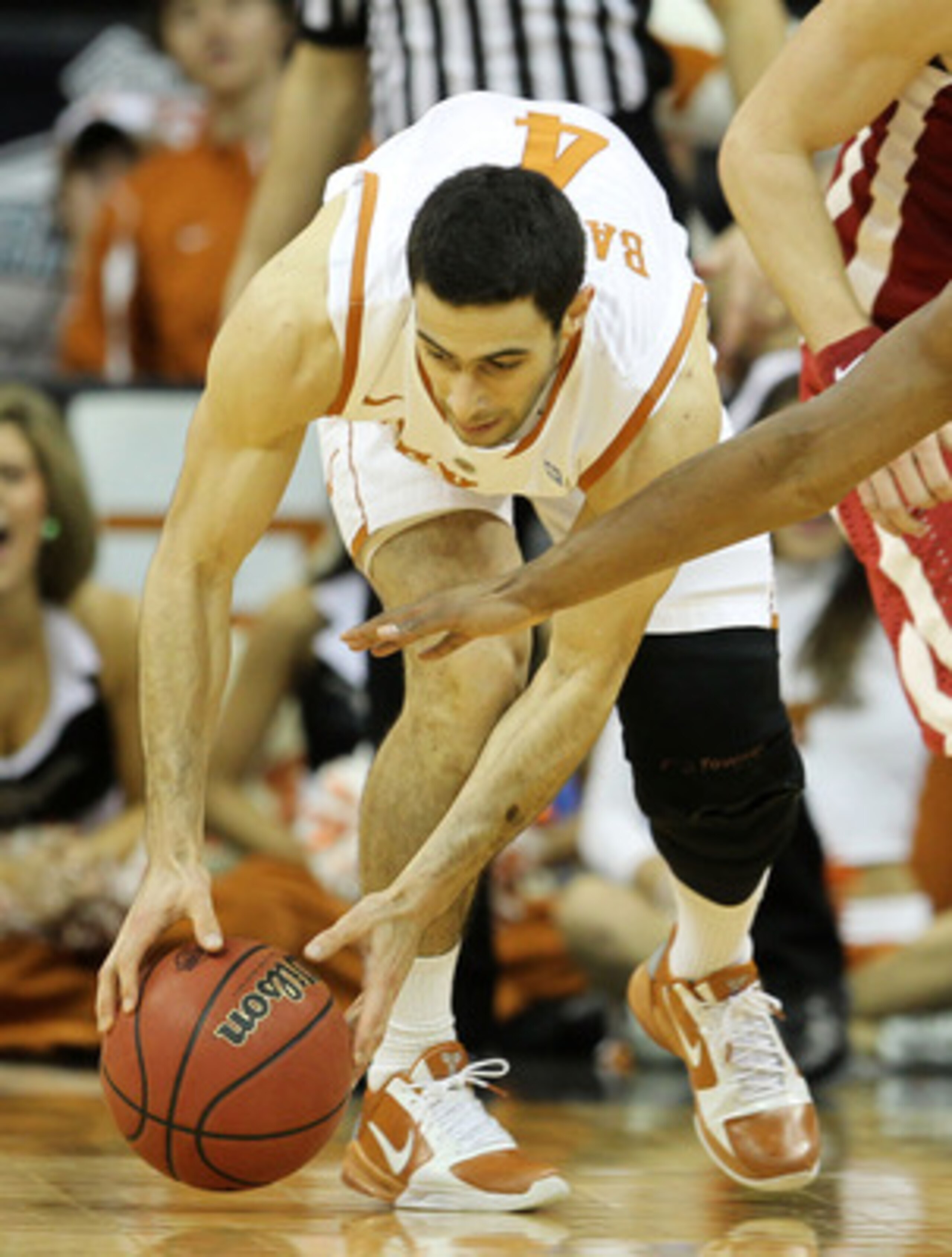 KANSAS CITY, MO - MARCH 10: Dogus Balbay #4 of the Texas Longhorns grabs the ball as Carl Blair #14 of the Oklahoma Sooners looks to steal during their quarterfinal game in the 2011 Phillips 66 Big 12 Men's Basketball Tournament at Sprint Center on March KANSAS CITY, MO - MARCH 10: Dogus Balbay #4 of the Texas Longhorns grabs the ball as Carl Blair #14 of the Oklahoma Sooners looks to steal during their quarterfinal game in the 2011 Phillips 66 Big 12 Men's Basketball Tournament at Sprint Center on March