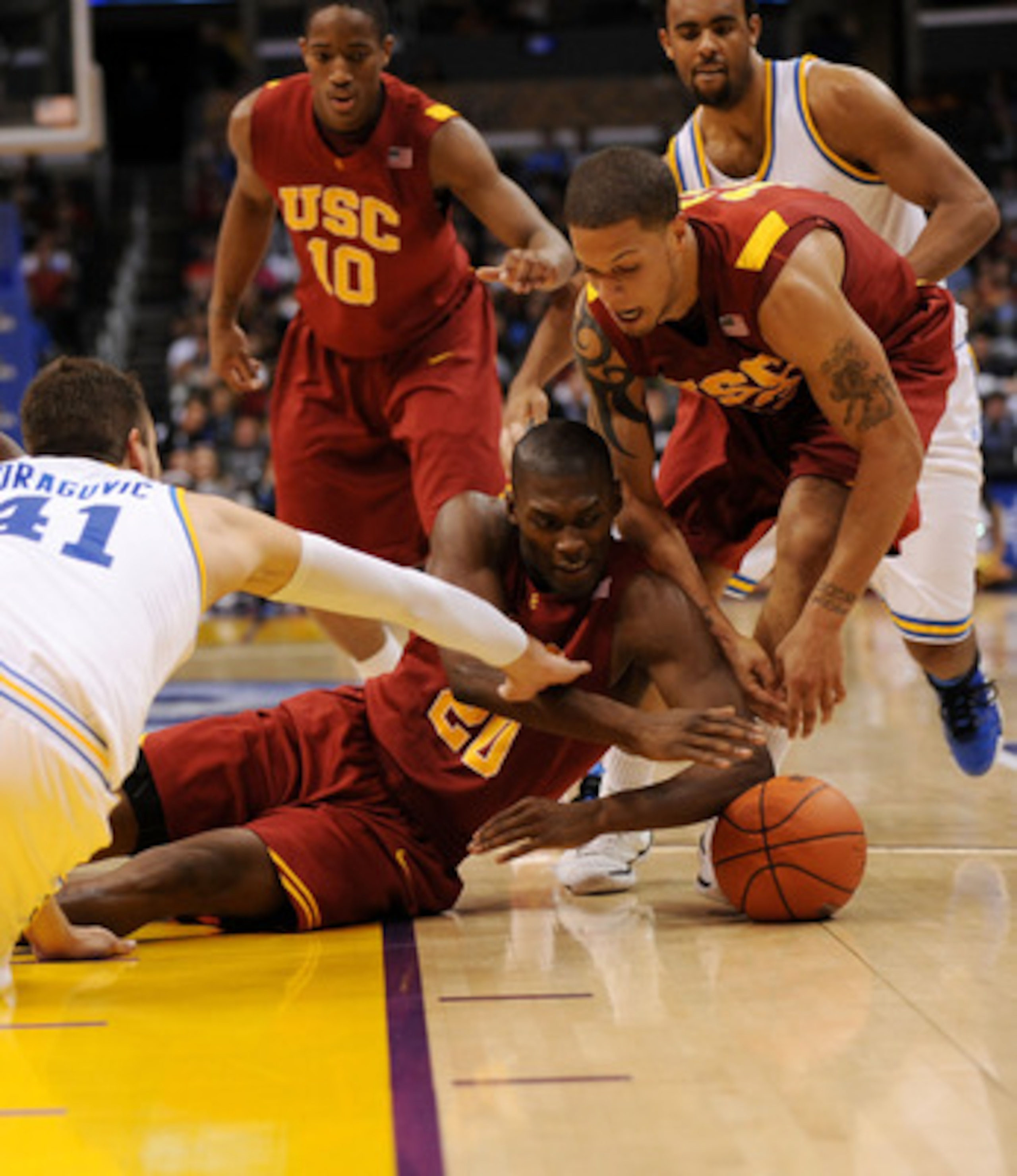LOS ANGELES, CA - MARCH 13: Guard Marcus Simmons #20 of the USC Trojans fights for the ball against the UCLA Bruins in the Pacific Life Pac-10 Men's Basketball Tournament at the Staples Center on March 13, 2009 in Los Angeles, California. (Photo by Harr LOS ANGELES, CA - MARCH 13: Guard Marcus Simmons #20 of the USC Trojans fights for the ball against the UCLA Bruins in the Pacific Life Pac-10 Men's Basketball Tournament at the Staples Center on March 13, 2009 in Los Angeles, California. (Photo by Harr
