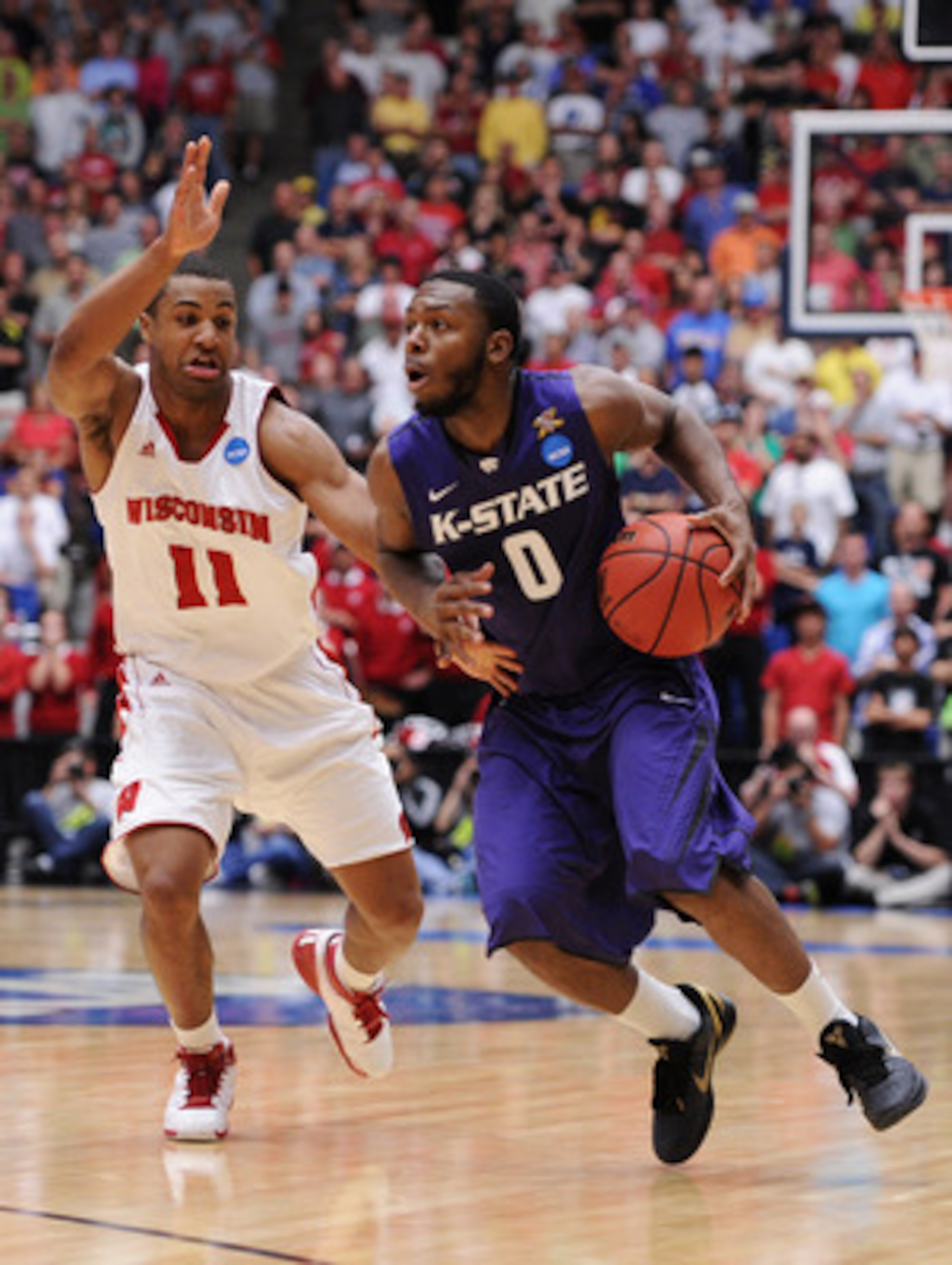TUCSON, AZ - MARCH 19:  Jacob Pullen #0 of the Kansas State Wildcats drives against Jordan Taylor #11 of the Wisconsin Badgers during the third round of the 2011 NCAA men's basketball tournament at McKale Center on March 19, 2011 in Tucson, Arizona.  (Pho