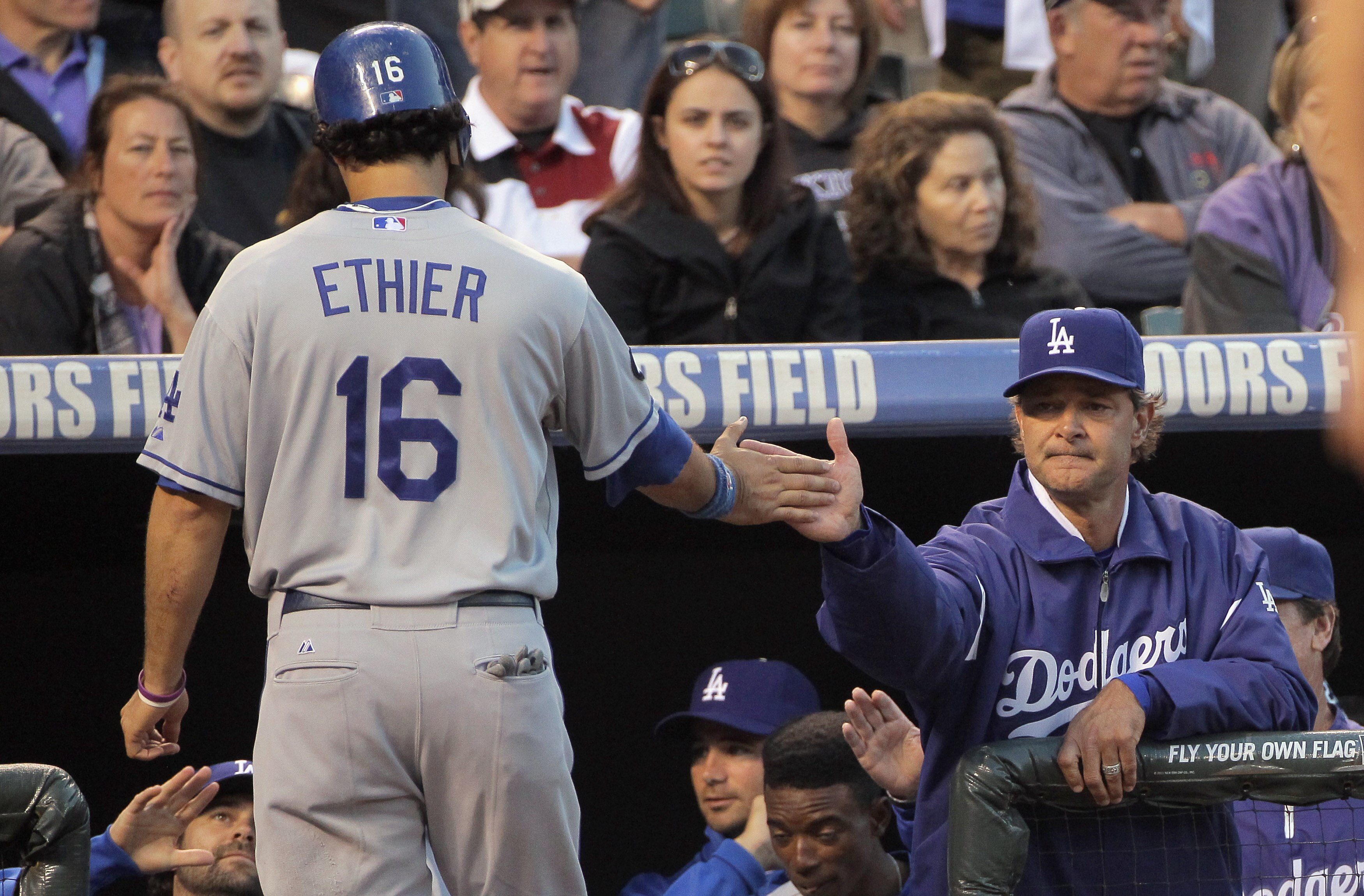DENVER, CO - JUNE 09:  Andre Ethier #16 of the Los Angeles Dodgers is welcomed back to the dugout by Manager Don Mattingly #8 of the Dodgers after Either and Casey Blake scored on a triple by Matt Kemp of the Dodgers to give the Dodgers a 4-0 lead in the 
