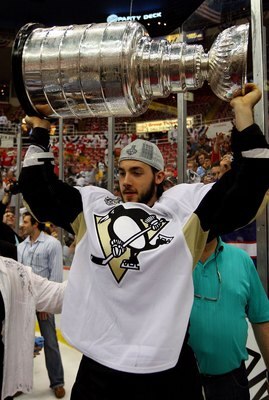 DETROIT - JUNE 12:  Kris Letang #58 of the Pittsburgh Penguins celebrates with the Stanley Cup after defeating the Detroit Red Wings by a score of 2-1 to win Game Seven and the 2009 NHL Stanley Cup Finals at Joe Louis Arena on June 12, 2009 in Detroit, Mi