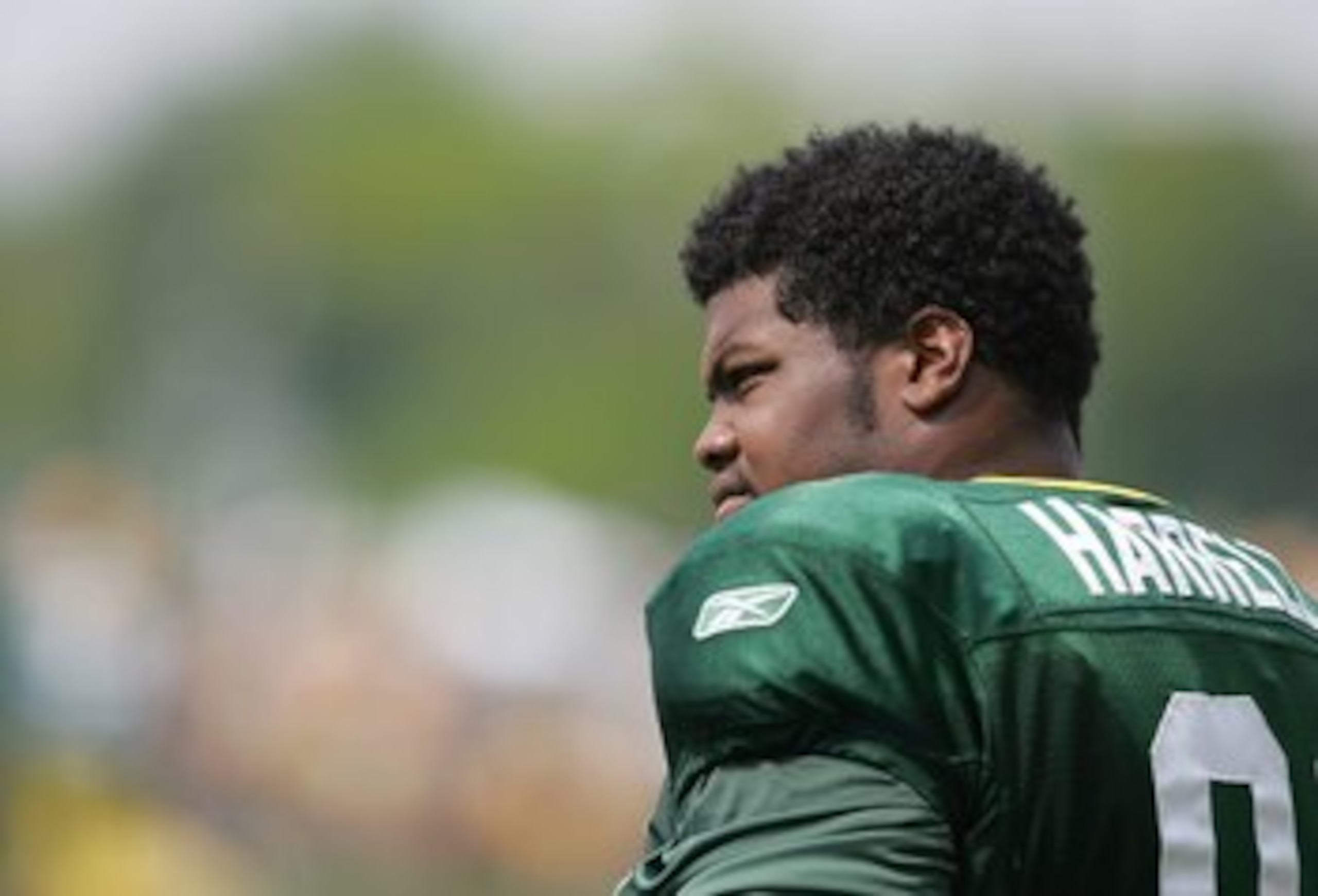 GREEN BAY, WI - AUGUST 6:  Justin Harrell #91 of the Green Bay Packers looks on during summer training camp on August 6, 2007 at the Hutson Center in Green Bay, Wisconsin. (Photo by Jonathan Daniel/Getty Images)