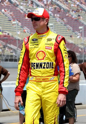 BROOKLYN, MI - JUNE 18:  Kurt Busch, driver of the #22 Shell/Pennzoil Dodge, walks on pit road during qualifying for the NASCAR Sprint Cup Series Heluva Good! Sour Cream Dips 400 at Michigan International Speedway on June 18, 2011 in Brooklyn, Michigan.