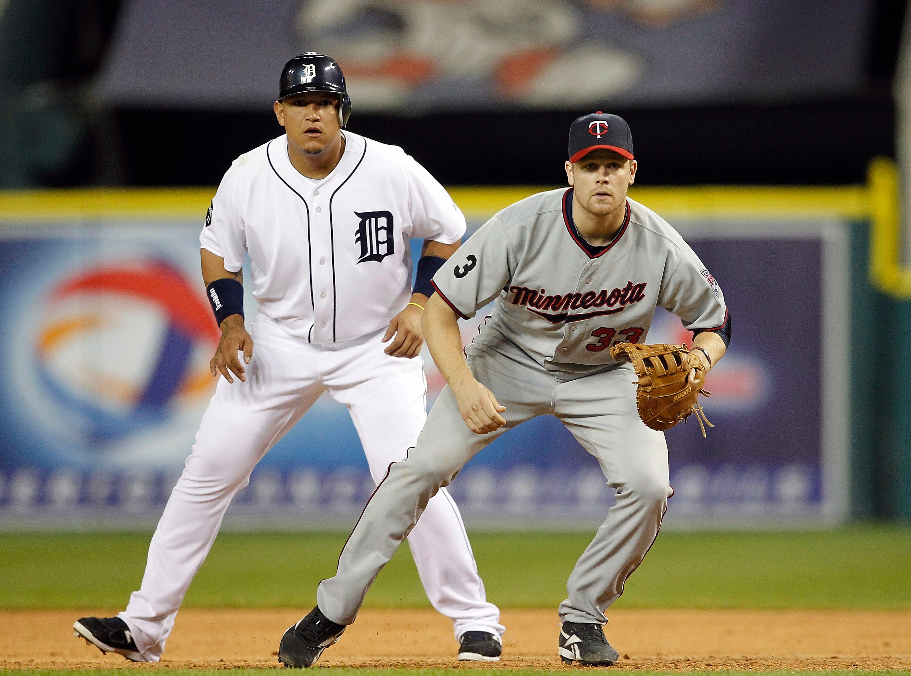 DETROIT - JUNE 01: Miguel Cabrera #24 of the Detroit Tigers and Justin Morneau #33 of the Minnesota Twins look towards home plate during the game at Comerica Park on June 1, 2011 in Detroit, Michigan. The Tigers defeated the Twins 4-2. (Photo by Leon Hali