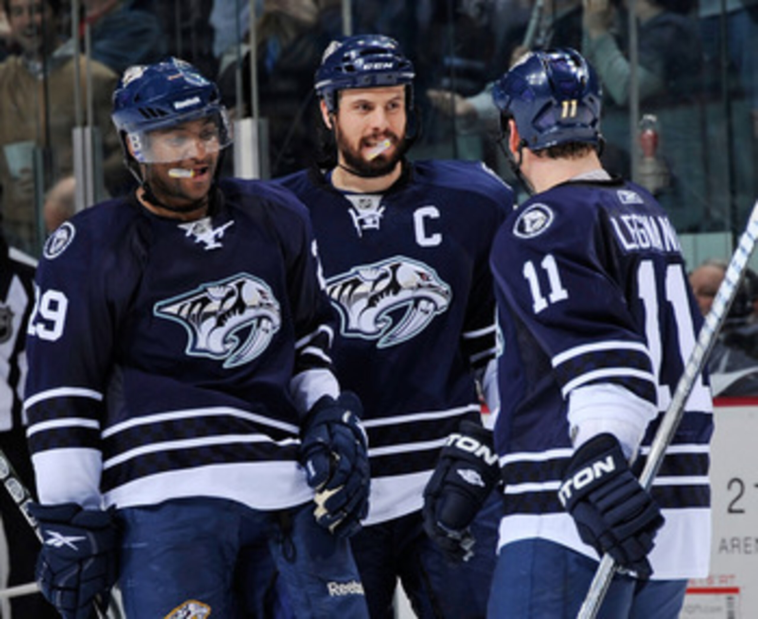 NASHVILLE, TN - MARCH 26:  Joel Ward #29 and Shea Weber #6 of the Nashville Predators congratulate teammate David Legwand #11 on scoring an open net goal against the Dallas Stars on March 26, 2011 at the Bridgestone Arena in Nashville, Tennessee.  (Photo