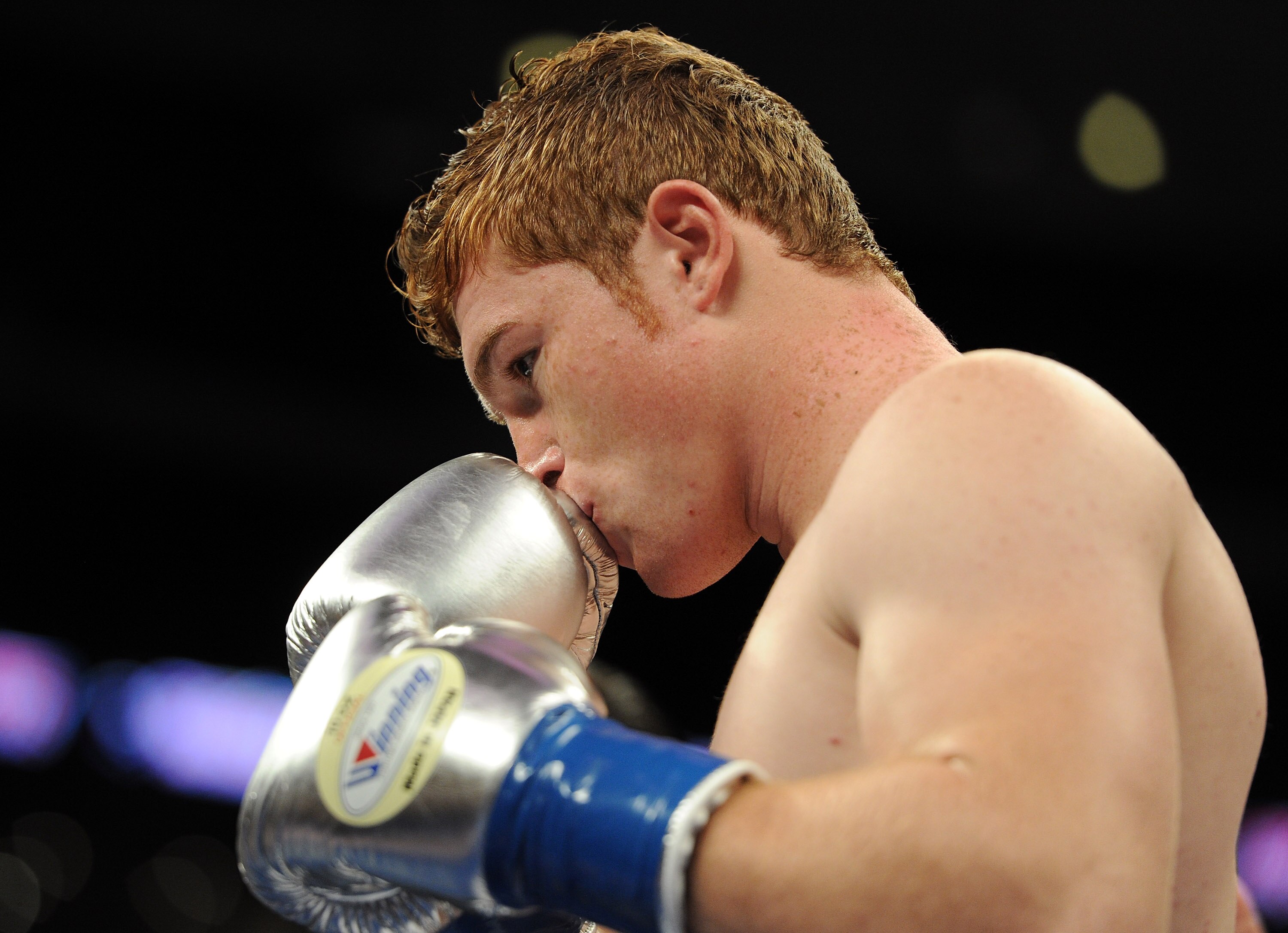 LOS ANGELES, CA - SEPTEMBER 18:  Saul Alvarez of Mexico Carlos kisses his gloves before his match against Baldomir of Argentina in the WBC Super Welterweight Silver Title fight at Staples Center on September 18, 2010 in Los Angeles, California.  (Photo by