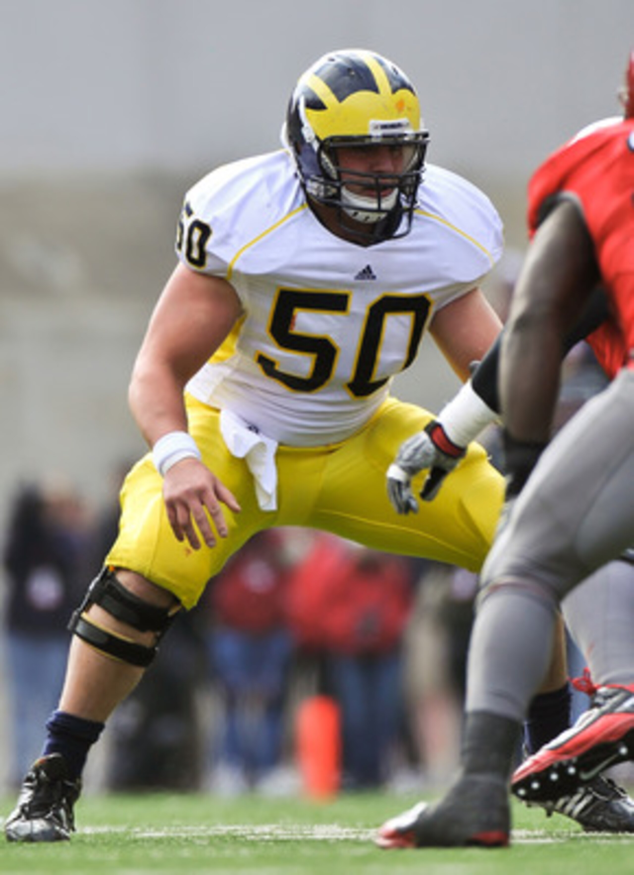 COLUMBUS, OH - NOVEMBER 27:  David Molk #50 of the Michigan Wolverines blocks against the Ohio State Buckeyes at Ohio Stadium on November 27, 2010 in Columbus, Ohio.  (Photo by Jamie Sabau/Getty Images)