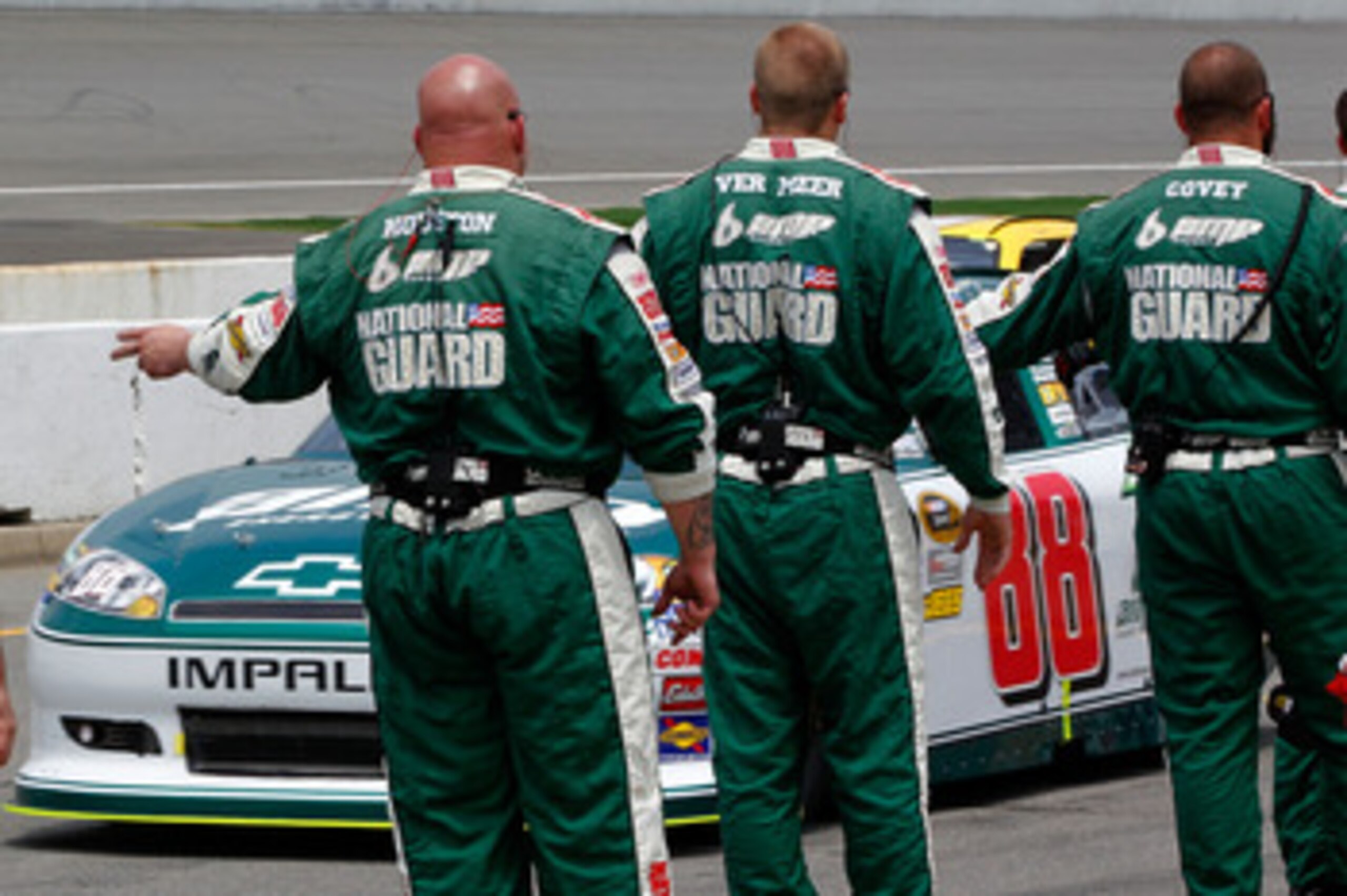 BROOKLYN, MI - JUNE 19:  Dale Earnhardt Jr., driver of the #88 Amp Energy/National Guard Chevrolet, drives past crew members on pit road prior to the NASCAR Sprint Cup Series Heluva Good! Sour Cream Dips 400 at Michigan International Speedway on June 19, 