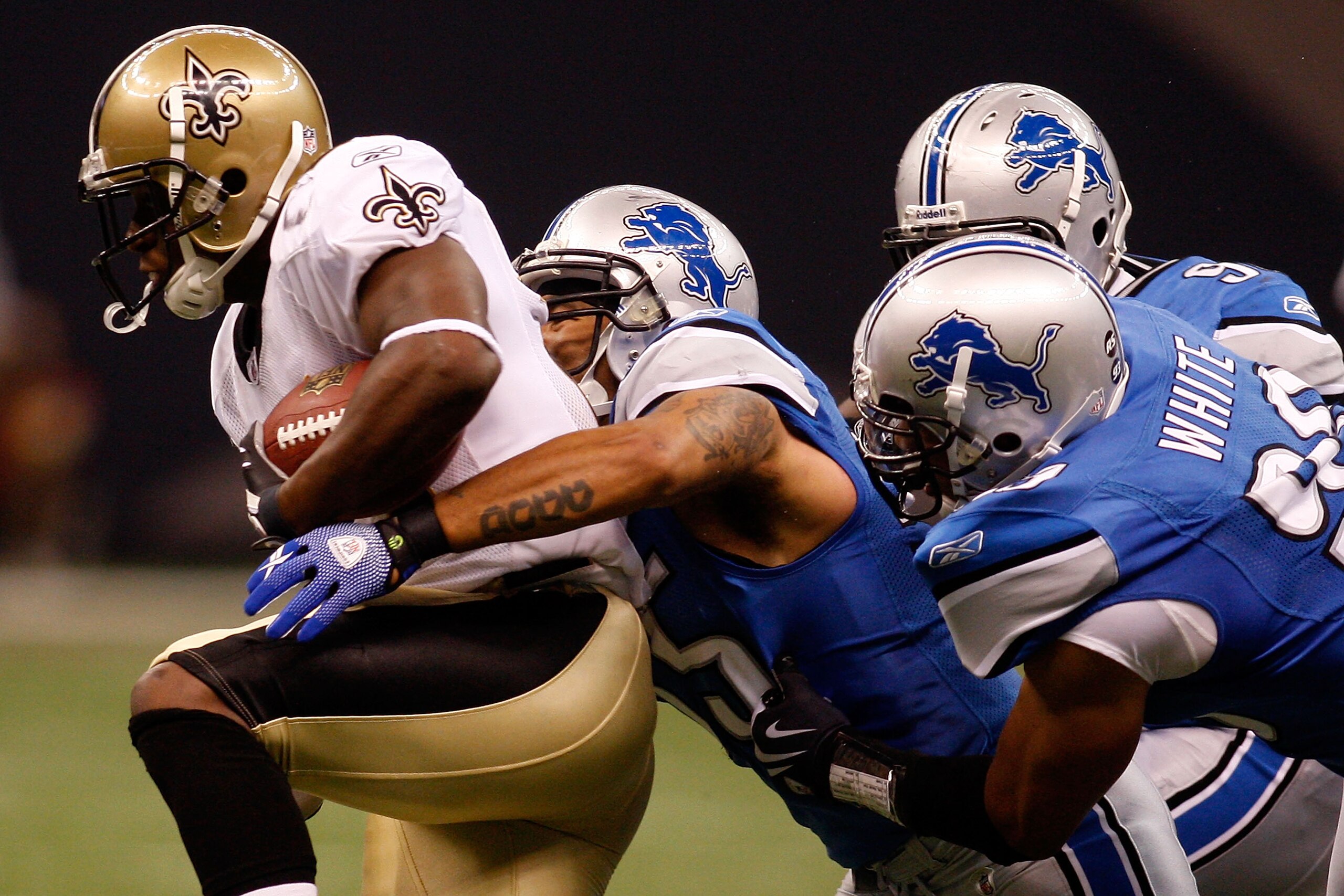 NEW ORLEANS - SEPTEMBER 13:  Mike Bell #21 of the New Orleans Saints is tackled by Larry Foote #55 of the Detroit Lions at the Louisiana Superdome on September 13, 2009 in New Orleans, Louisiana.  (Photo by Chris Graythen/Getty Images)