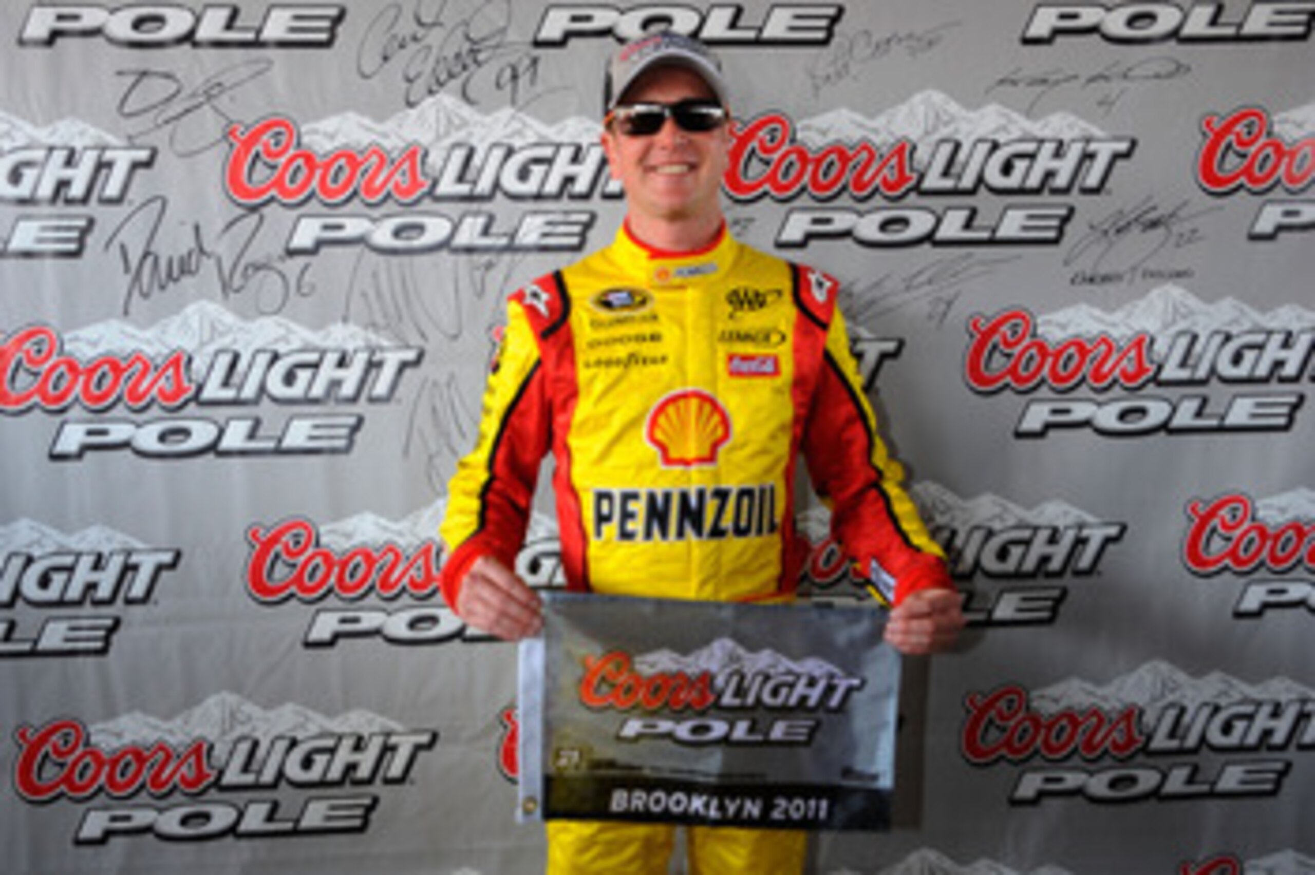 BROOKLYN, MI - JUNE 18:  Kurt Busch, driver of the #22 Shell/Pennzoil Dodge, celebrates setting the pole position following qualifying for the NASCAR Sprint Cup Series Heluva Good! Sour Cream Dips 400 at Michigan International Speedway on June 18, 2011 in