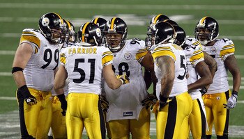 ARLINGTON, TX - FEBRUARY 06:  James Farrior #51 of the Pittsburgh Steelers calls a play in the defensive huddle as Brett Keisel #99 and Casey Hampton #98 (c) look on against the Green Bay Packers during Super Bowl XLV at Cowboys Stadium on February 6, 201