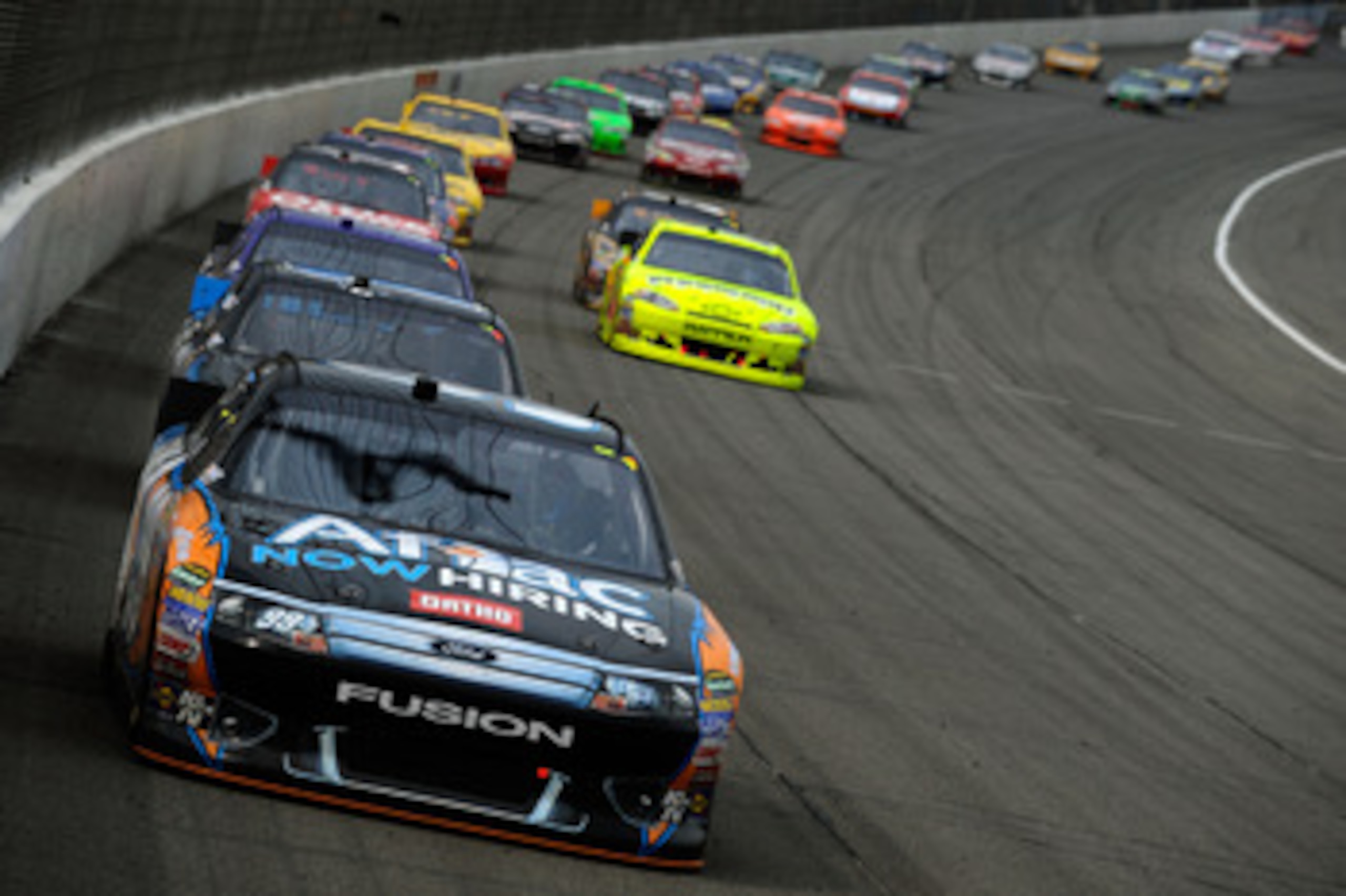 BROOKLYN, MI - JUNE 19:  Carl Edwards, driver of the #99 Aflac Ford, leads the field into turn one during the NASCAR Sprint Cup Series Heluva Good! Sour Cream Dips 400 at Michigan International Speedway on June 19, 2011 in Brooklyn, Michigan.  (Photo by J