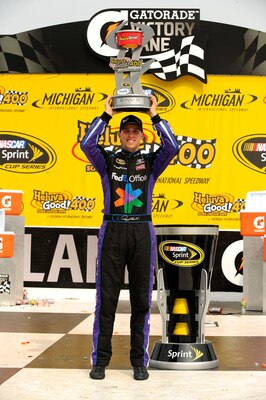 BROOKLYN, MI - JUNE 19:  Denny Hamlin, driver of the #11 FedEx Office Toyota, celebrates in victory lane after winning the NASCAR Sprint Cup Series Heluva Good! Sour Cream Dips 400 at Michigan International Speedway on June 19, 2011 in Brooklyn, Michigan.