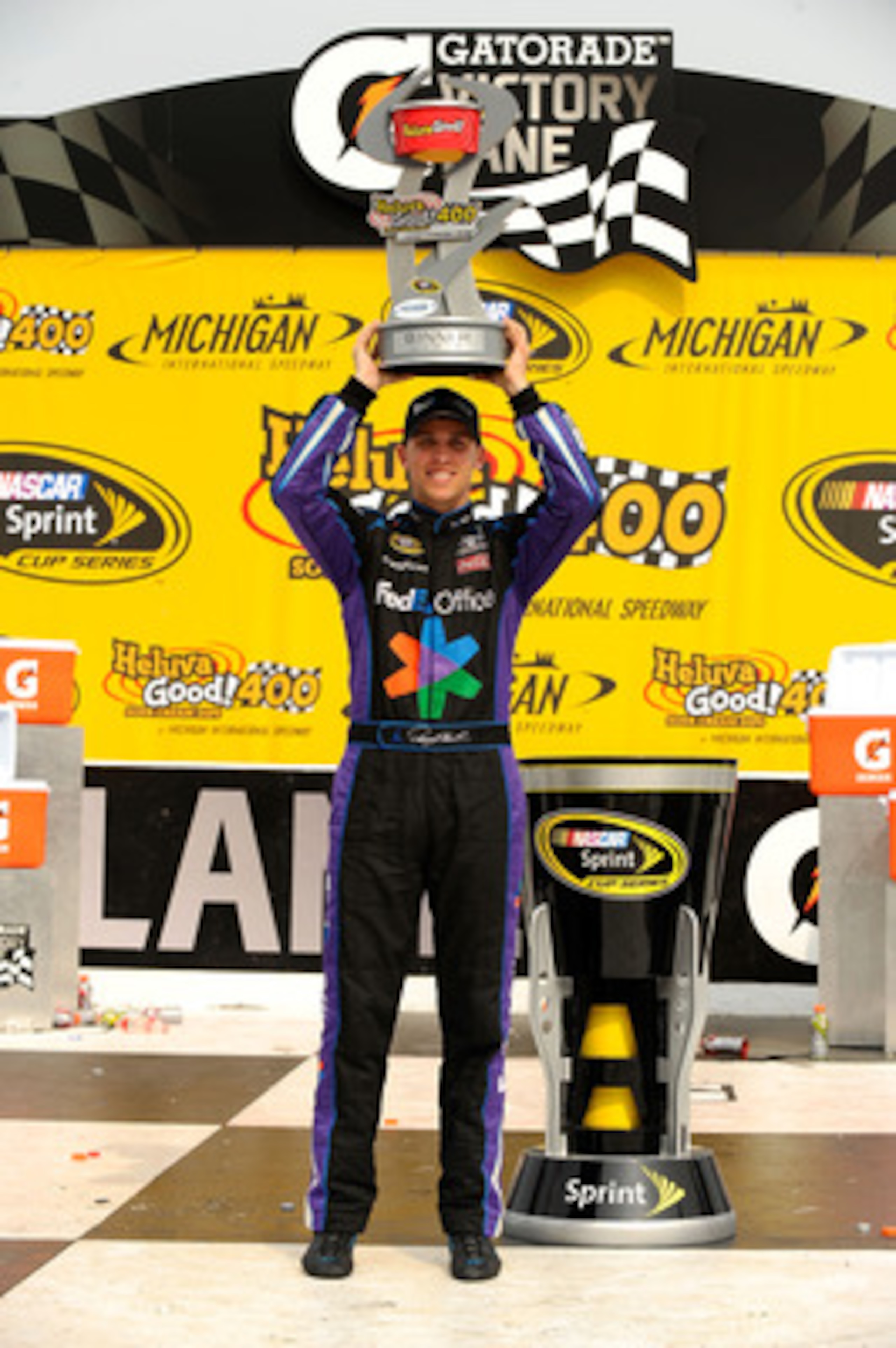 BROOKLYN, MI - JUNE 19:  Denny Hamlin, driver of the #11 FedEx Office Toyota, celebrates in victory lane after winning the NASCAR Sprint Cup Series Heluva Good! Sour Cream Dips 400 at Michigan International Speedway on June 19, 2011 in Brooklyn, Michigan.