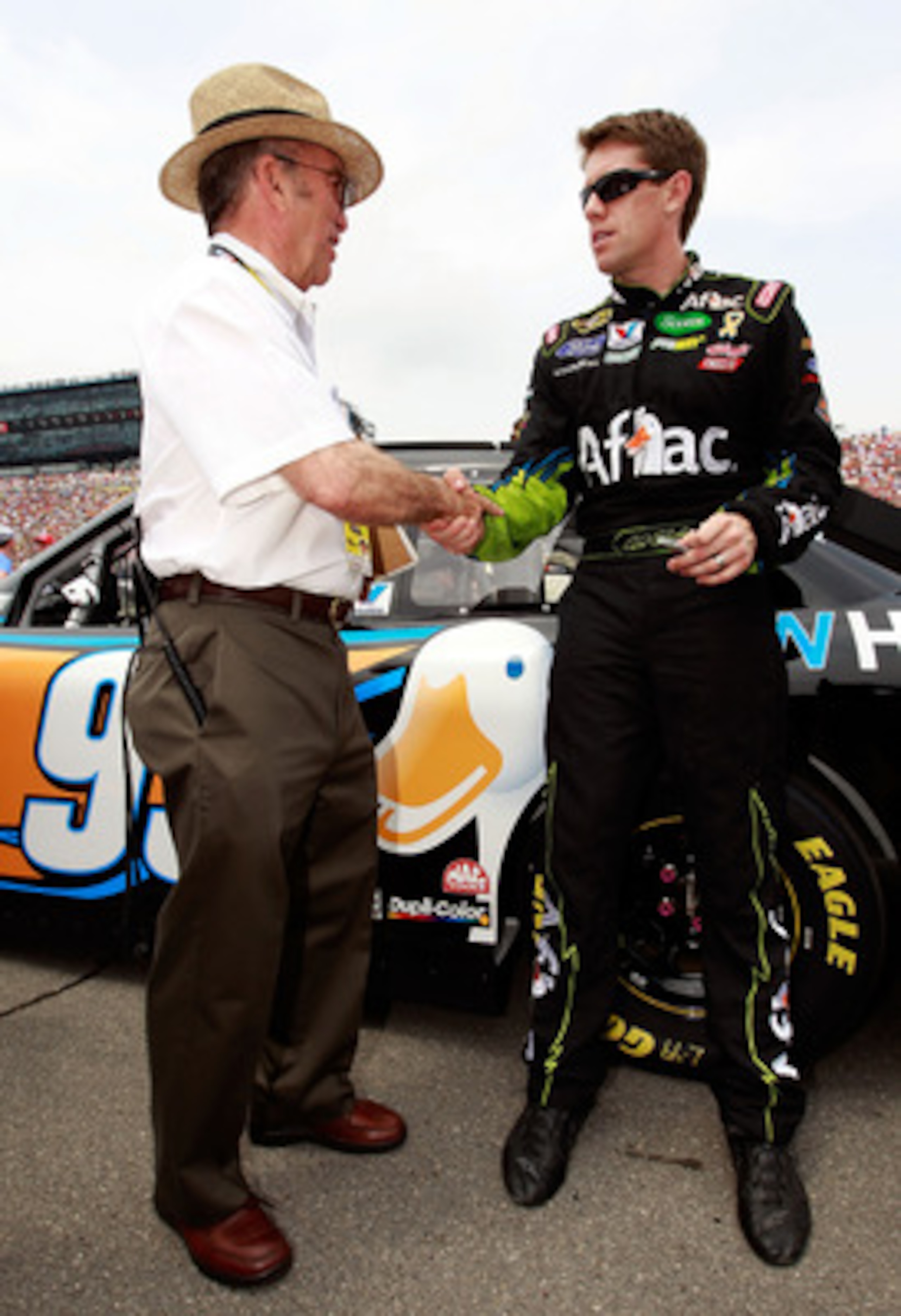 BROOKLYN, MI - JUNE 19:  Carl Edwards, driver of the #99 Aflac Ford, greets team owner Jack Roush prior to the NASCAR Sprint Cup Series Heluva Good! Sour Cream Dips 400 at Michigan International Speedway on June 19, 2011 in Brooklyn, Michigan.  (Photo by 