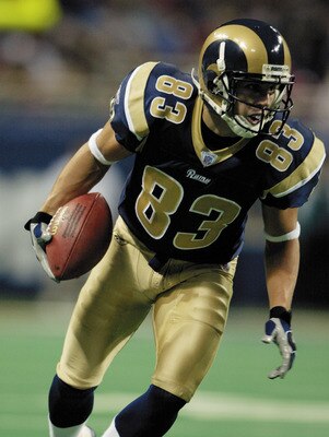 ST. LOUIS, MO - AUGUST 18:  Wide receiver Kevin Curtis #83 of the St. Louis Rams runs with the ball against the Tampa Bay Buccaneers during the NFL preseason game at the Edward Jones Dome on August 18, 2003 in St. Louis, Missouri.  The Rams defeated the B