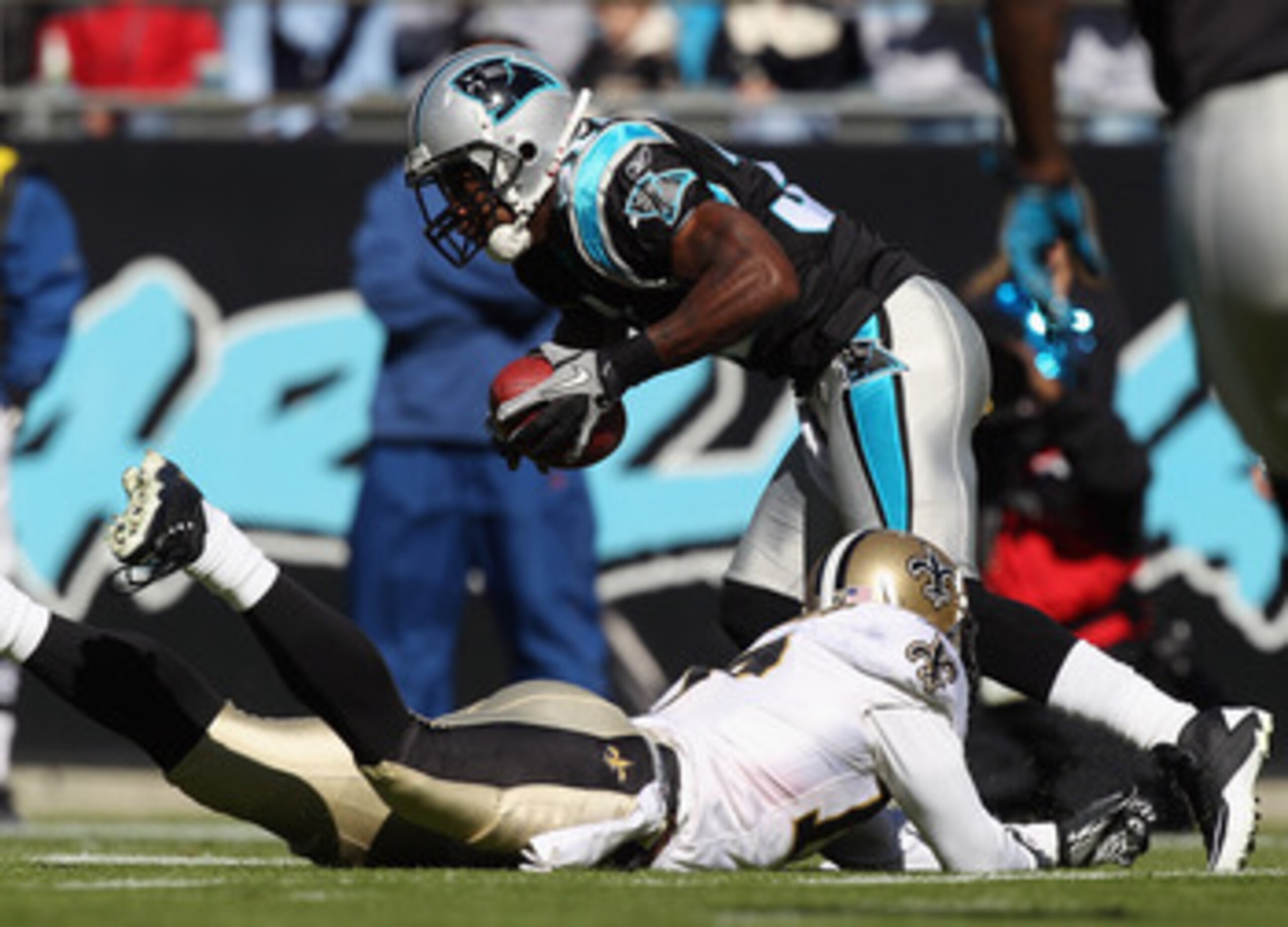 CHARLOTTE, NC - NOVEMBER 07:  Robert Meachem #17 of the New Orleans Saints tries to tackle Richard Marshall #31 of the Carolina Panthers after an interception during their game at Bank of America Stadium on November 7, 2010 in Charlotte, North Carolina.