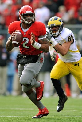 COLUMBUS, OH - NOVEMBER 27:  Quarterback Terrelle Pryor #2 of the Ohio State Buckeyes rolls out of the pocket looking for his receiver as Craig Roh #88 of the Michigan Wolverines pursues at Ohio Stadium on November 27, 2010 in Columbus, Ohio.  (Photo by J