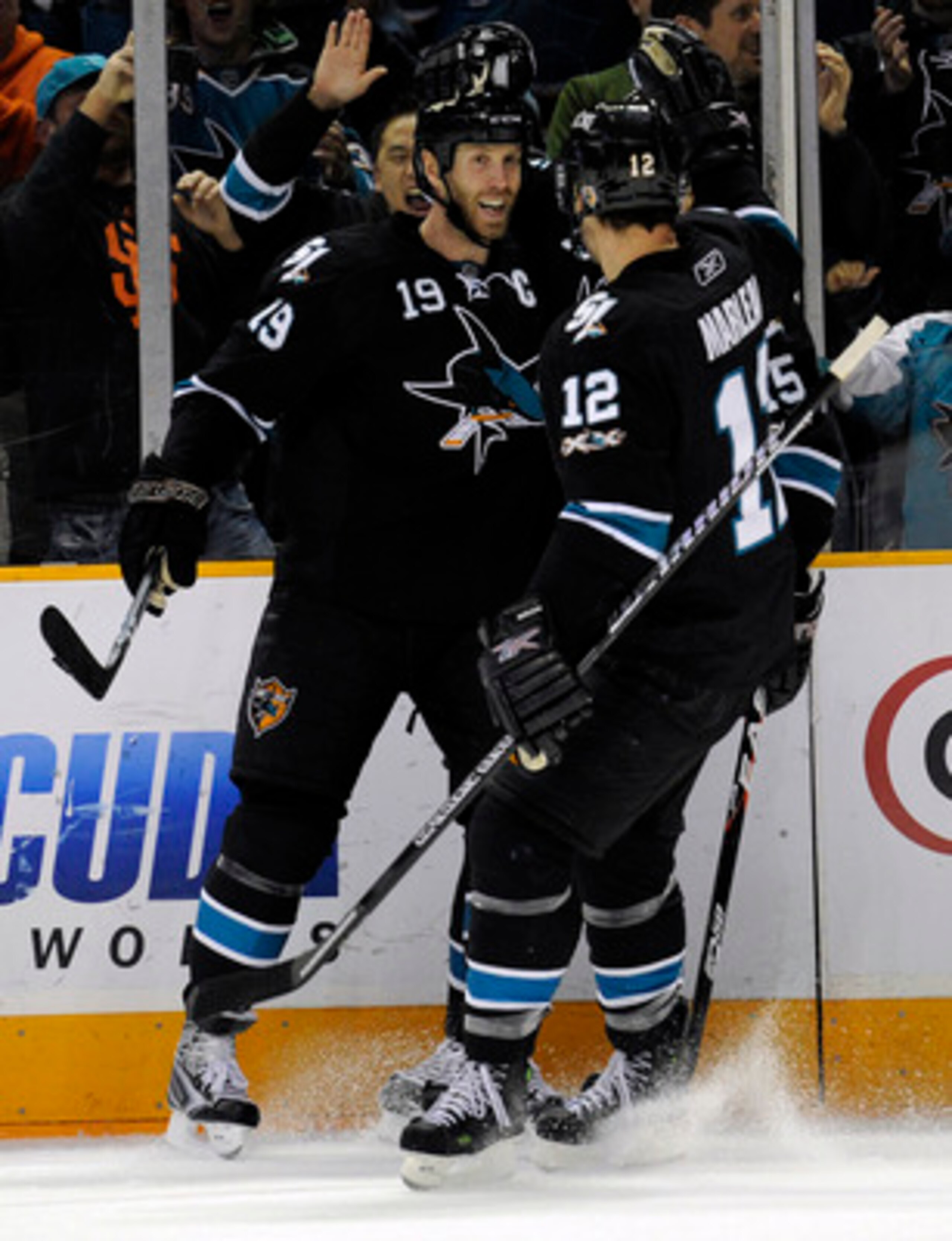 SAN JOSE, CA - DECEMBER 23: Joe Thornton #19 of the San Jose Sharks after scoring a goal celebrates with teammates Patrick Marleau #12 and Dany Heatley #15 against the Phoenix Coyotes during an NHL hockey game at the HP Pavilion on December 23, 2010 in Sa