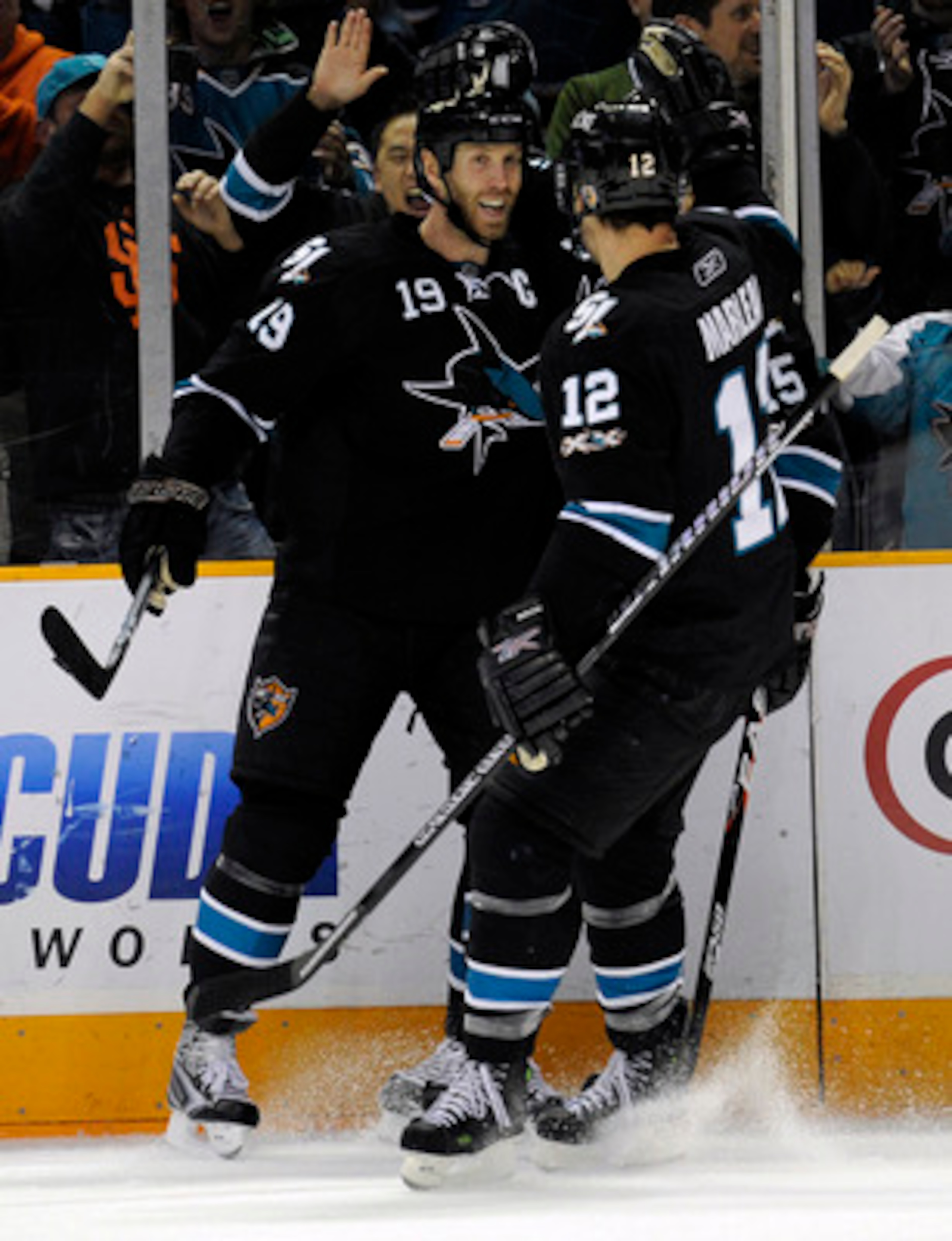 SAN JOSE, CA - DECEMBER 23: Joe Thornton #19 of the San Jose Sharks after scoring a goal celebrates with teammates Patrick Marleau #12 and Dany Heatley #15 against the Phoenix Coyotes during an NHL hockey game at the HP Pavilion on December 23, 2010 in Sa