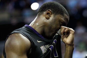 CHARLOTTE, NC - MARCH 20:  Matthew Bryan-Amaning #11 of the Washington Huskies reacts after the Huskies were defeated 86-83 by the North Carolina Tar Heels during the third round of the 2011 NCAA men's basketball tournament at Time Warner Cable Arena on M