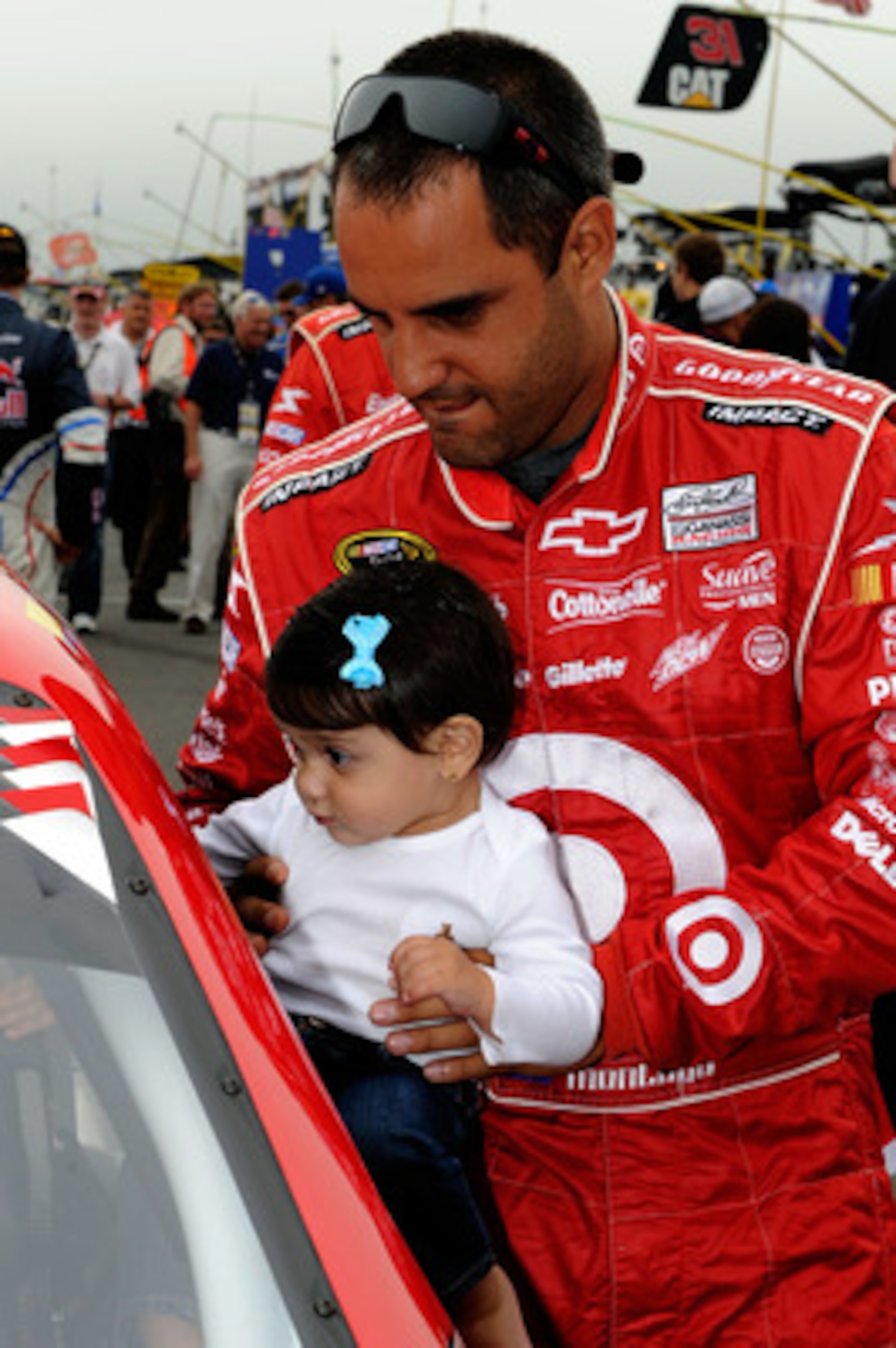 LONG POND, PA - JUNE 12:  Juan Pablo Montoya, driver of the #42 Target Chevrolet, holds his daughter Manuela on the grid prior to the NASCAR Sprint Cup Series 5-Hour Energy 500 at Pocono Raceway on June 12, 2011 in Long Pond, Pennsylvania.  (Photo by John