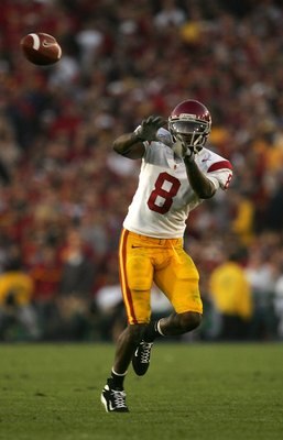 PASADENA, CA - JANUARY 01:  Dwayne Jarrett #8 of the USC Trojans catches a pass over the defense of the Michigan Wolverines on January 1, 2007 at the Rose Bowl in Pasadena, California.  (Photo by Stephen Dunn/Getty Images)