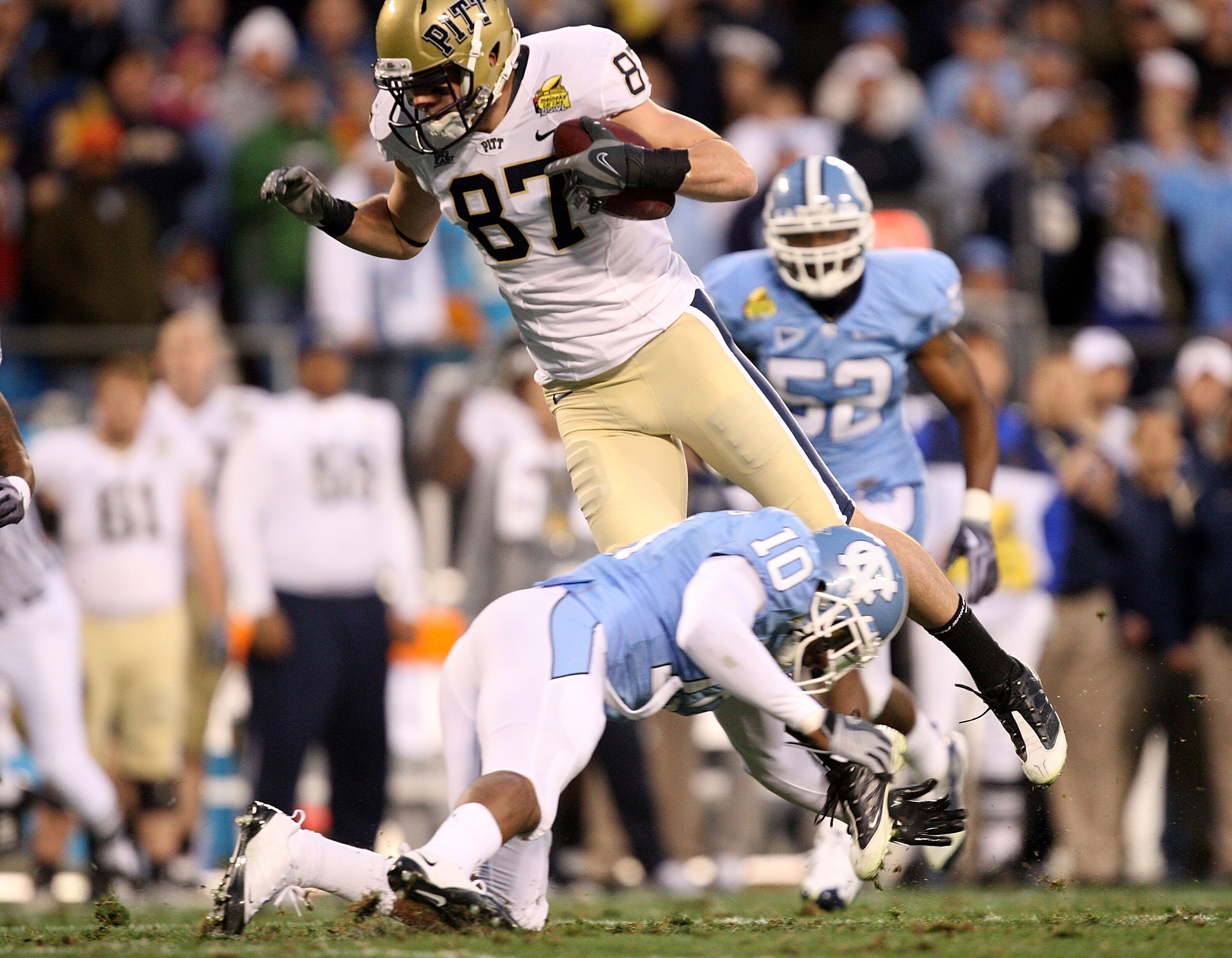CHARLOTTE, NC - DECEMBER 26:  Mike Shanahan #87 of the Pittsburgh Panthers jumps over Melvin Williams #10 of the North Carolina Tar Heels during their game on December 26, 2009 in Charlotte, North Carolina.  (Photo by Streeter Lecka/Getty Images)