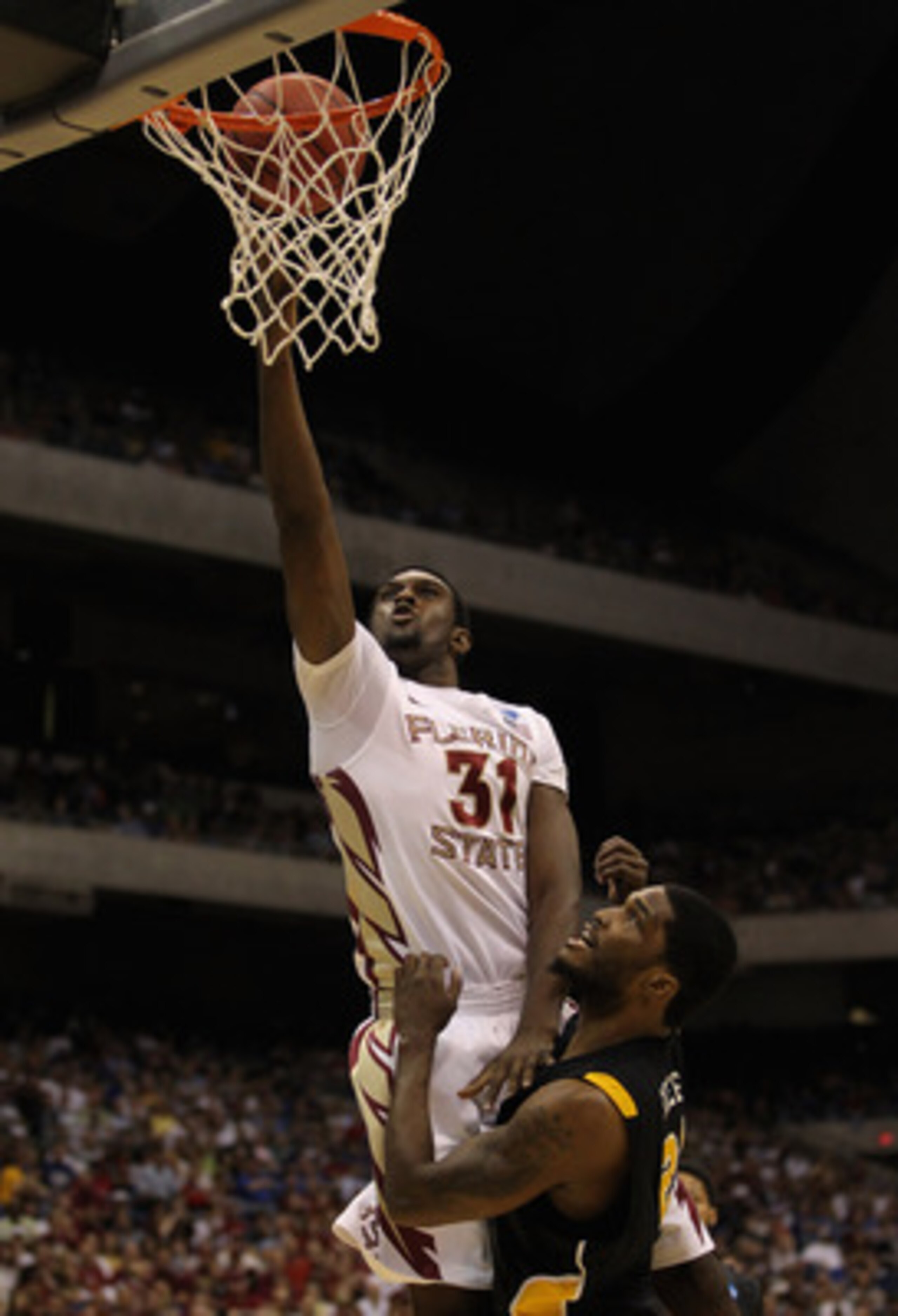 SAN ANTONIO, TX - MARCH 25:  Chris Singleton #31 of the Florida State Seminoles goes to the basket against Jamie Skeen #21 of the Virginia Commonwealth Rams during the southwest regional of the 2011 NCAA men's basketball tournament at the Alamodome on Mar