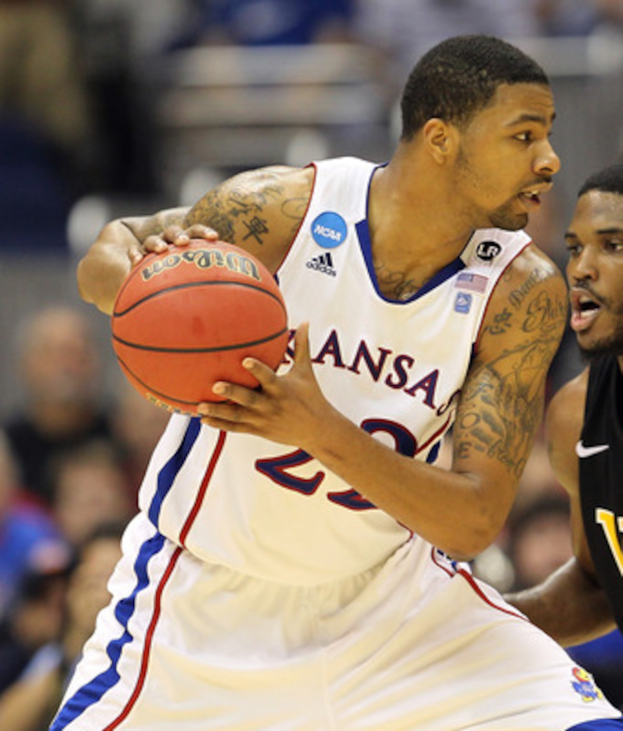 SAN ANTONIO, TX - MARCH 27:  Marcus Morris #22 of the Kansas Jayhawks handles the ball against Jamie Skeen #21 of the Virginia Commonwealth Rams during the southwest regional final of the 2011 NCAA men's basketball tournament at the Alamodome on March 27,