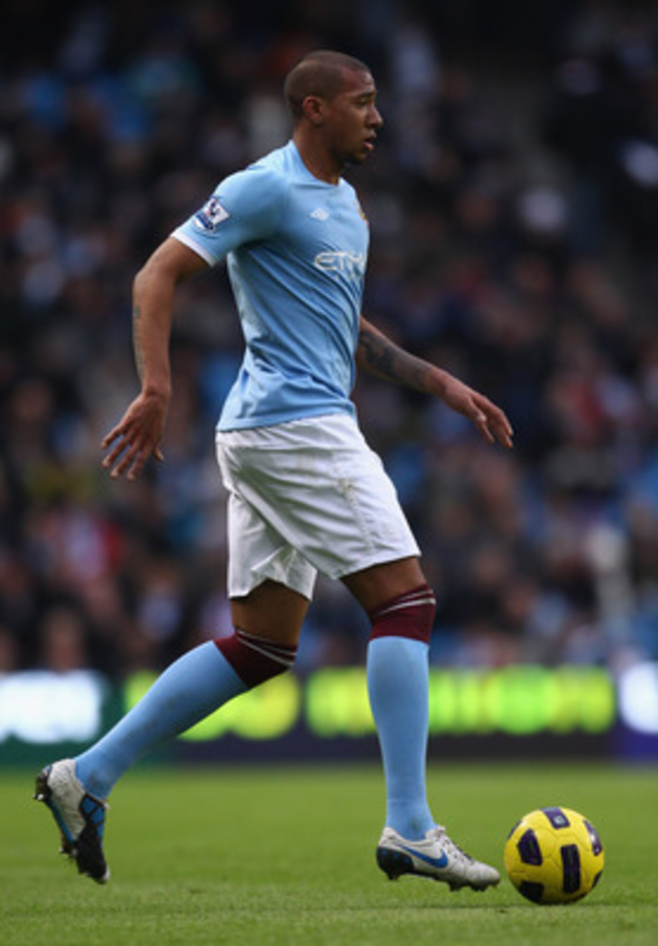 MANCHESTER, ENGLAND - JANUARY 01:  Jerome Boatang of Manchester City runs with the ball during the Barclays Premier League match between Manchester City and Blackpool at the City of Manchester Stadium on January 1, 2011 in Manchester, England.  (Photo by 