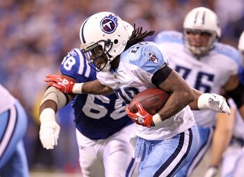 INDIANAPOLIS - JANUARY 02:  Chris Johnson #28 of the Tennessee Titans is tackled by Eric Foster #68 of the Indianapolis Colts at Lucas Oil Stadium on January 2, 2011 in Indianapolis, Indiana.  the Colts won 23-20.  (Photo by Andy Lyons/Getty Images)