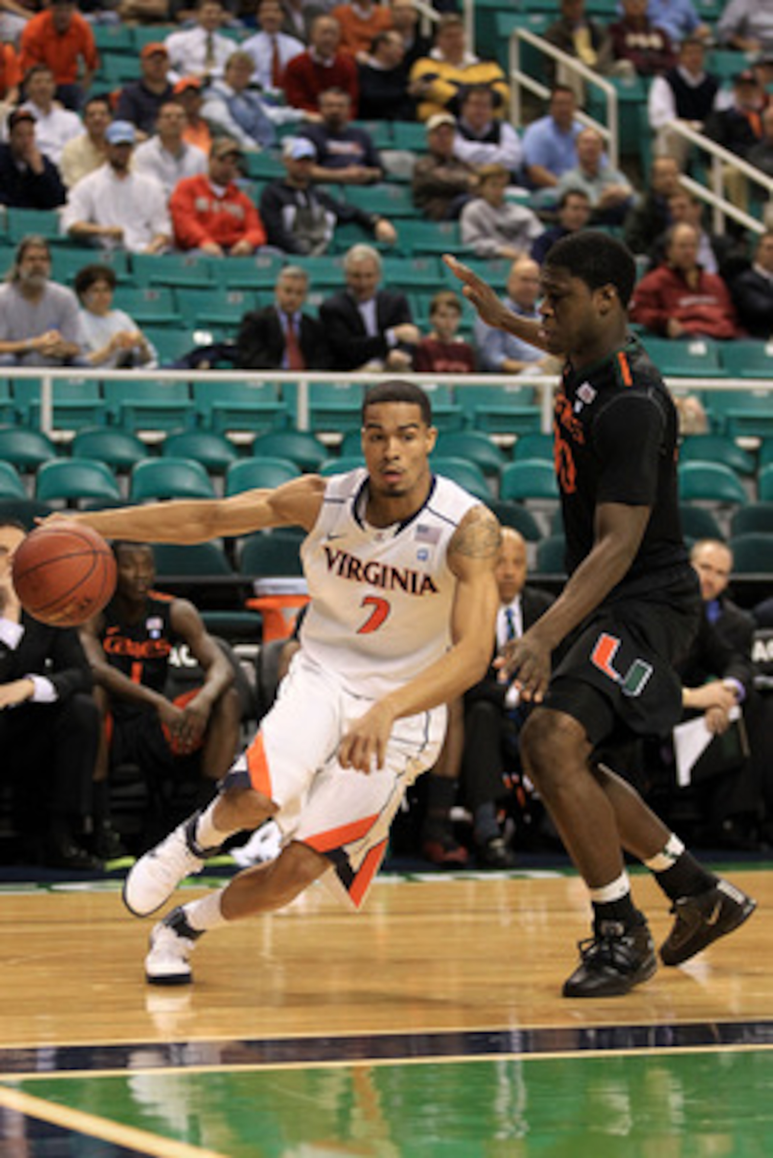GREENSBORO, NC - MARCH 10:  Mustapha Farrakhan #2 of the Virginia Cavaliers drives against Adrian Thomas #30 of the Miami Hurricanes during the first round of the 2011 ACC men's basketball tournament at the Greensboro Coliseum on March 10, 2011 in Greensb