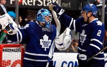TORONTO - OCTOBER 26: Jean-Sebastien Giguere #35 and Luke Schenn #2 of the Toronto Maple Leafs celebrate win against the Florida Panthers during game action at the Air Canada Centre October 26, 2010 in Toronto, Ontario, Canada. The Leafs won 3-1. (Photo b TORONTO - OCTOBER 26: Jean-Sebastien Giguere #35 and Luke Schenn #2 of the Toronto Maple Leafs celebrate win against the Florida Panthers during game action at the Air Canada Centre October 26, 2010 in Toronto, Ontario, Canada. The Leafs won 3-1. (Photo b